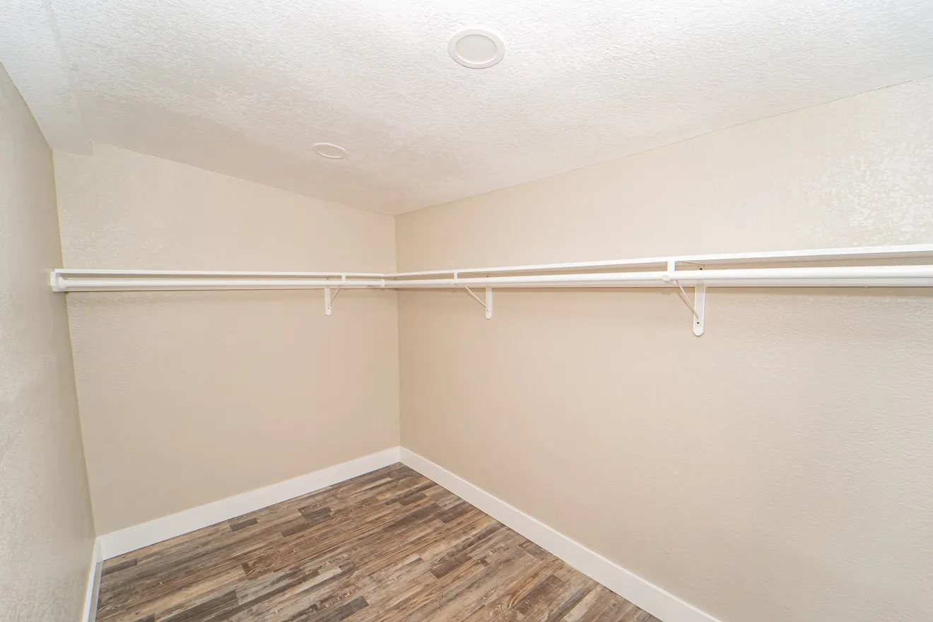 Spacious closet featuring dark wood finished floors