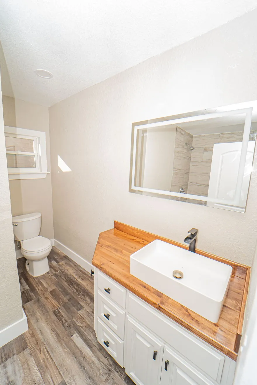 Bathroom featuring vanity, dark wood finished floors, and a textured ceiling