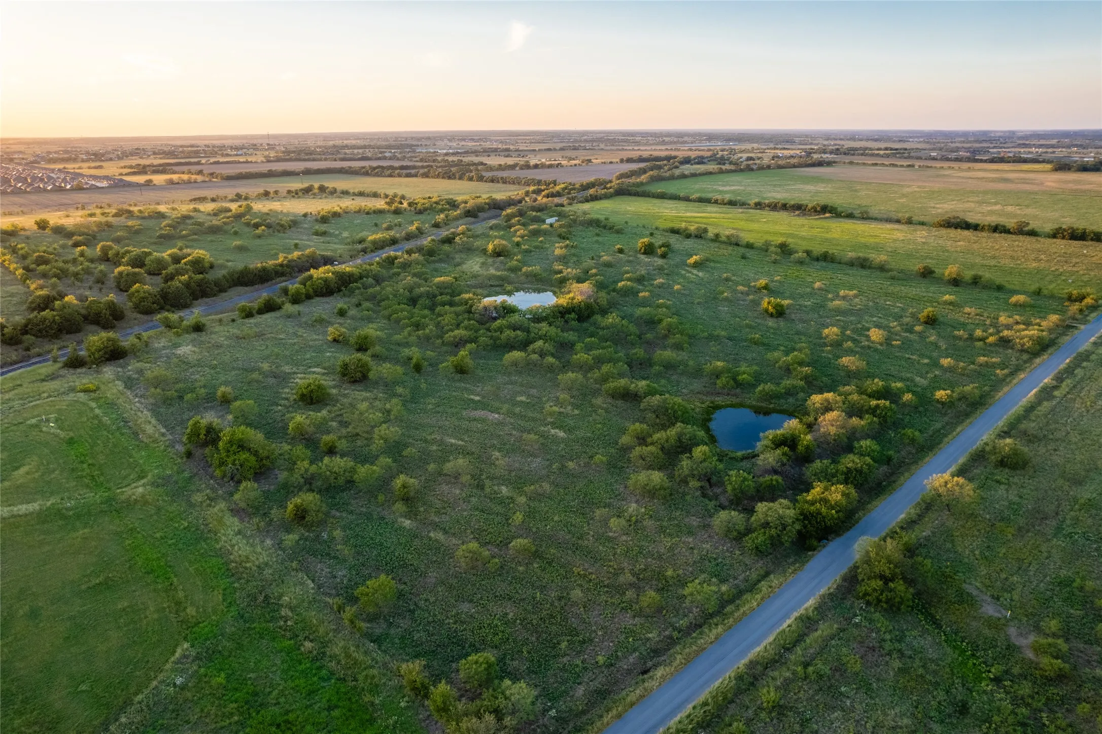 Aerial view at dusk of a view of rural / pastoral area and a water view