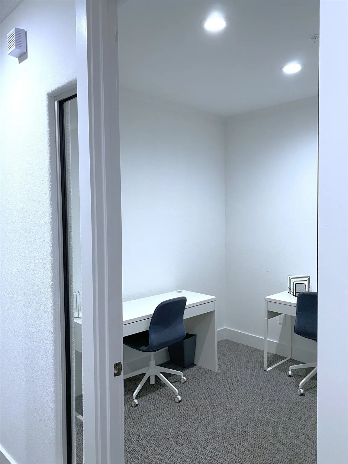 9x8. Furnished with 2 desks and 2 chairs.