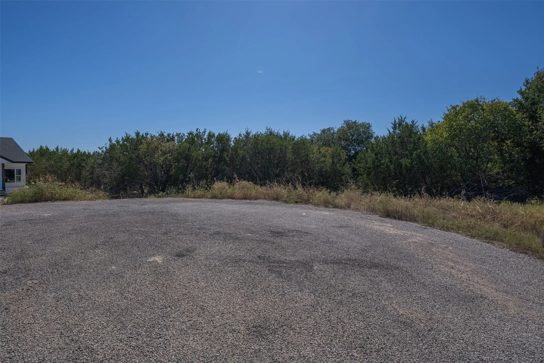 View of asphalt road featuring a view of trees