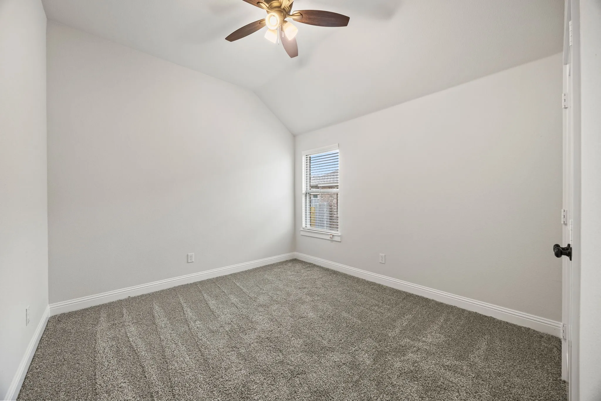 Unfurnished room with carpet, lofted ceiling, and ceiling fan