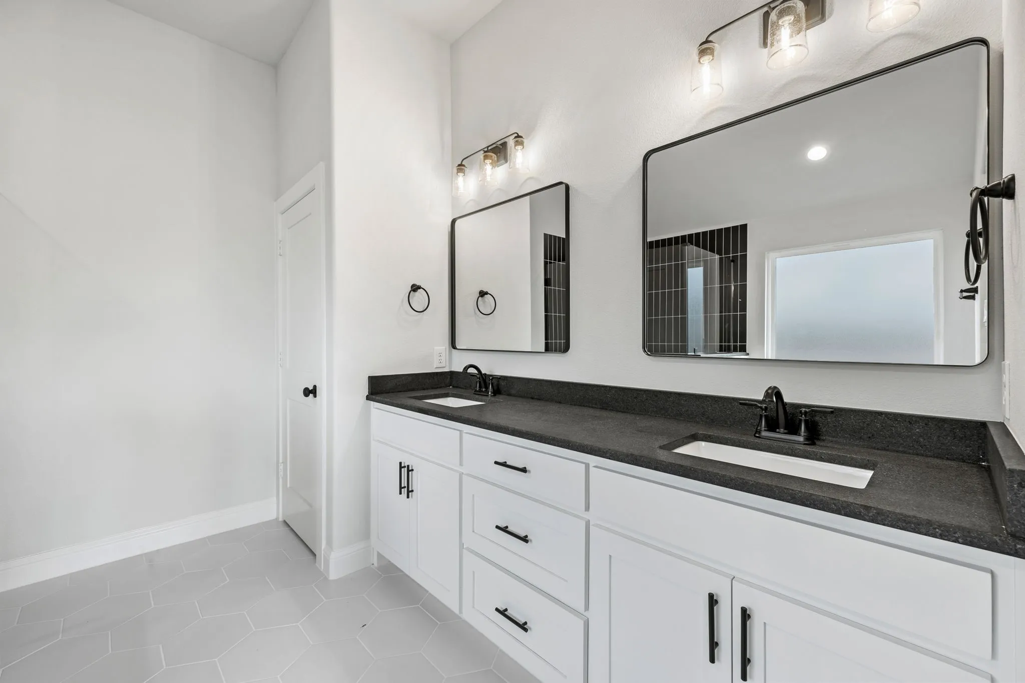 Bathroom featuring light tile patterned floors and double vanity