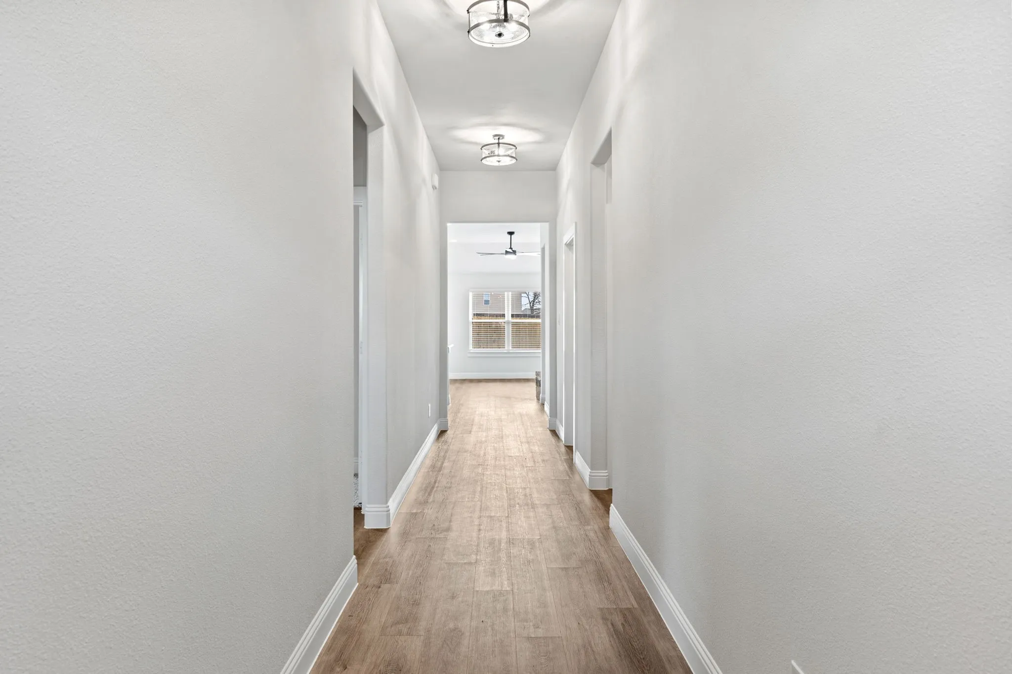 Hall featuring baseboards and light wood-style flooring