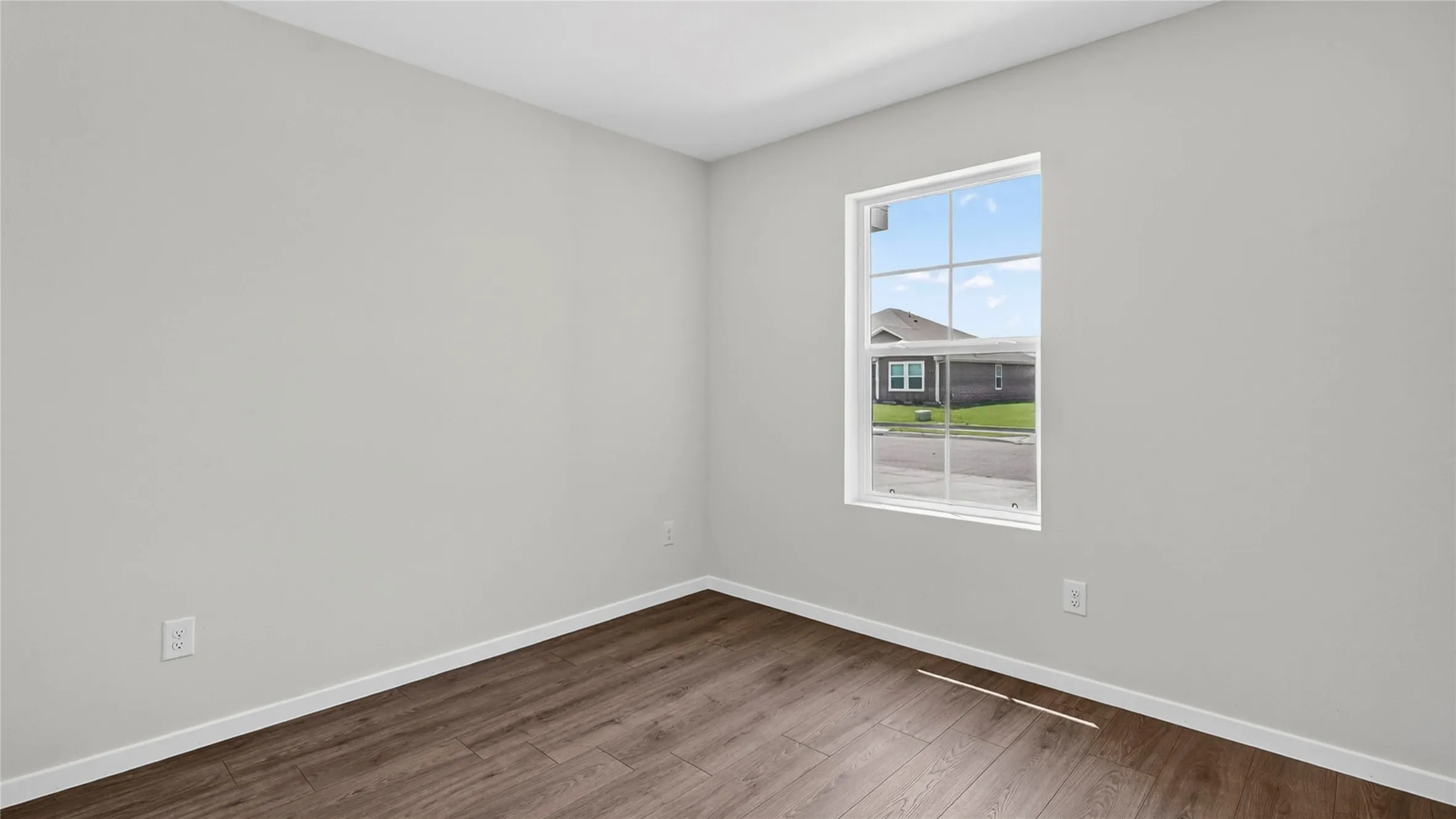Neutral wall color with wood-finish flooring