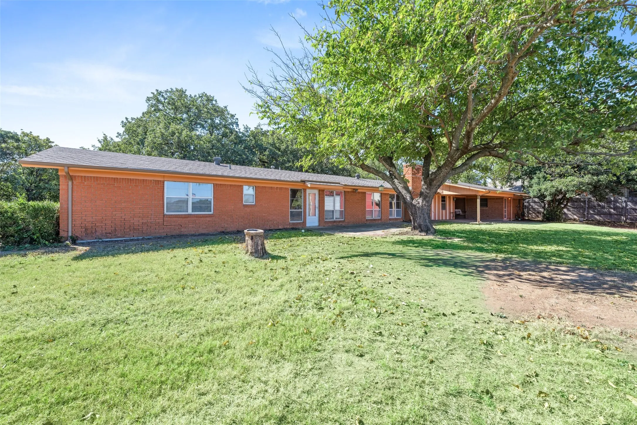 Ranch-style home with a front yard and brick siding