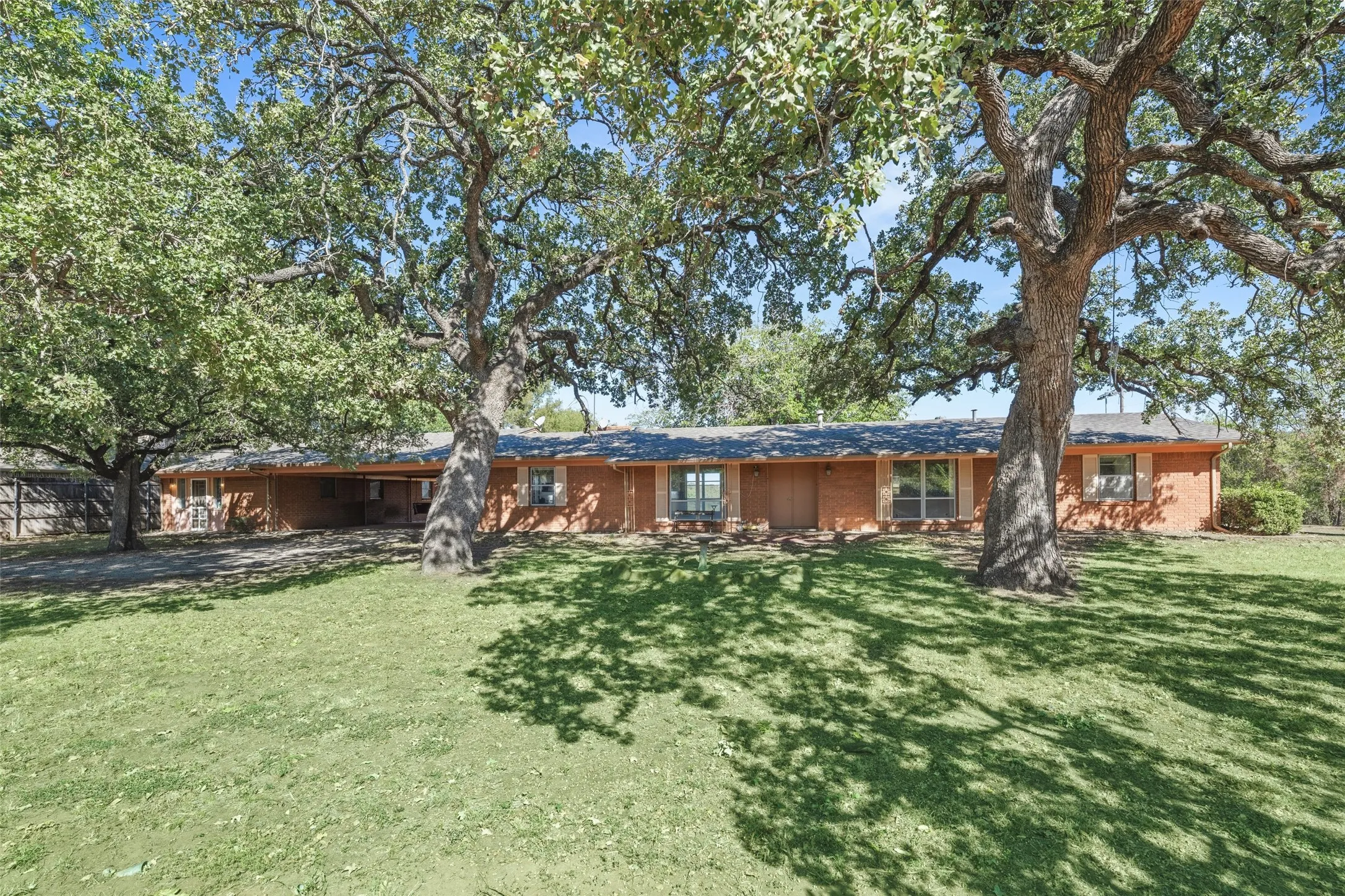 View of front of home featuring a front yard and brick siding