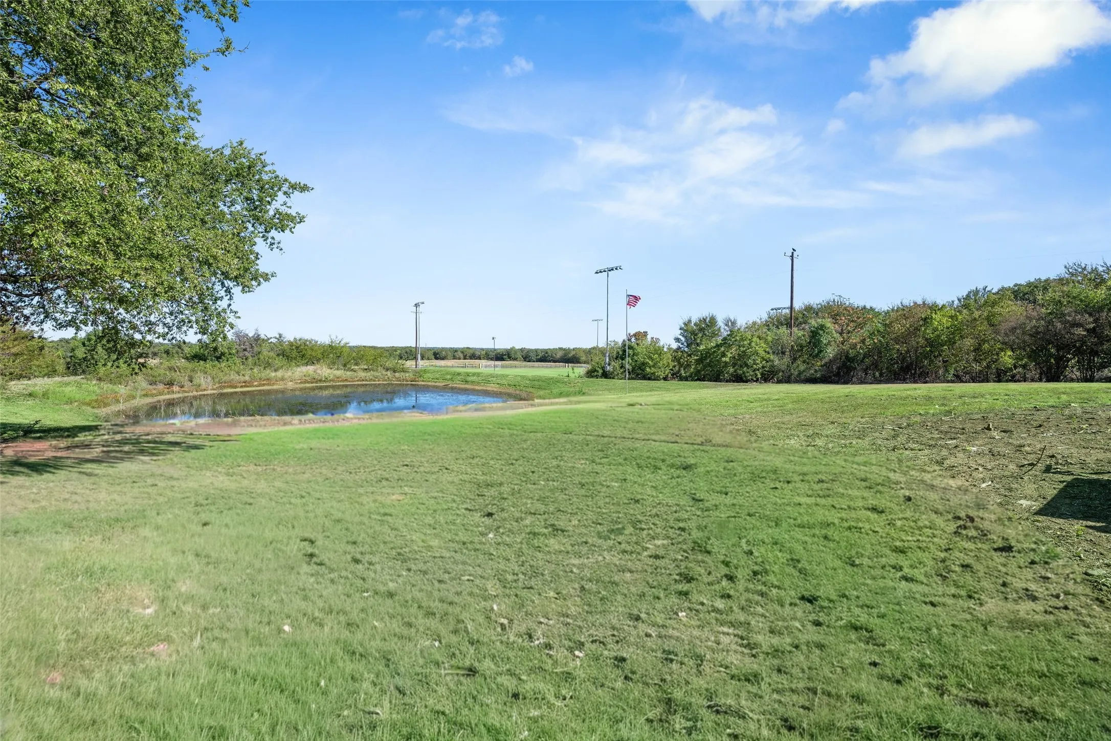 View of property's community featuring a water view and a lawn