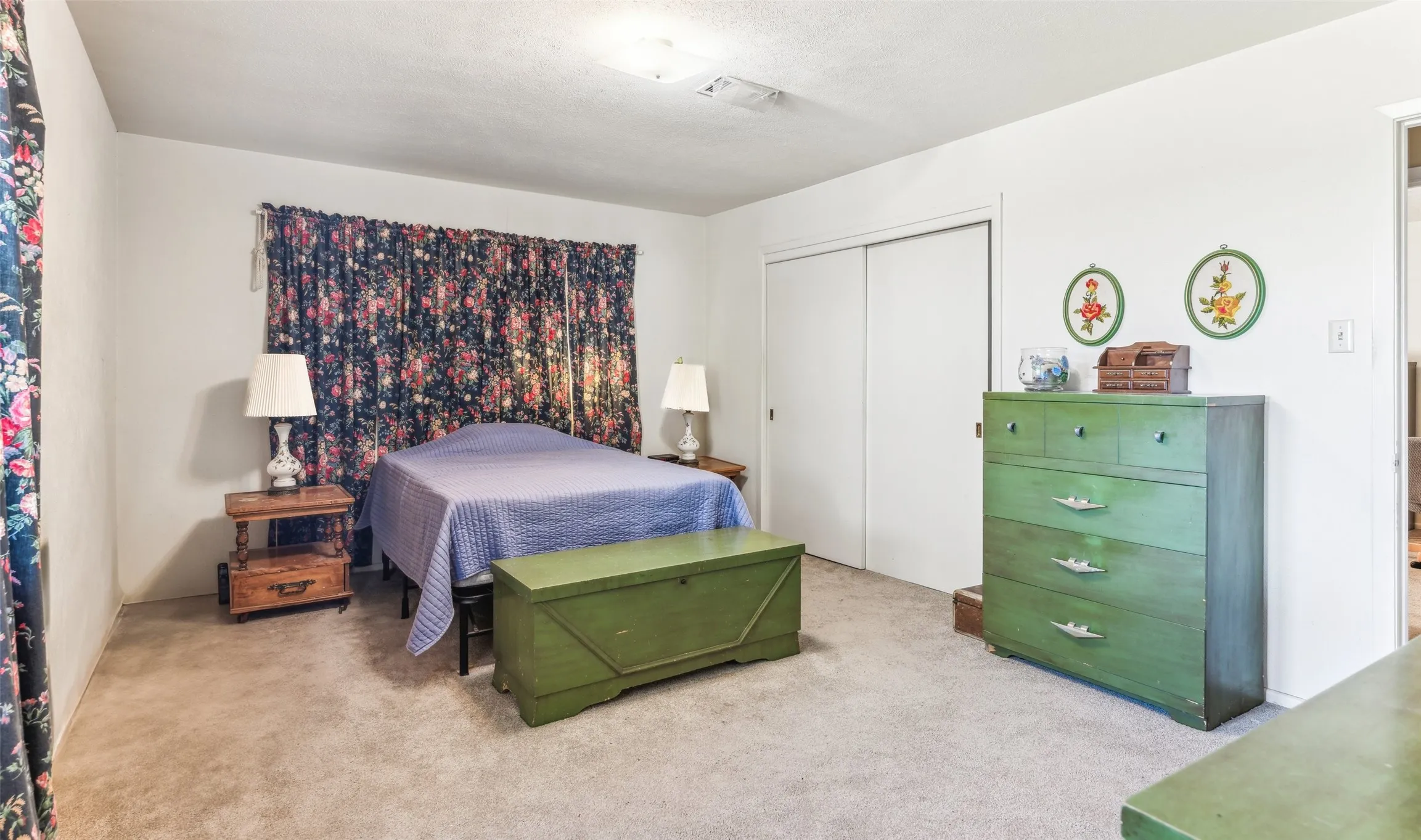 Carpeted bedroom with a closet