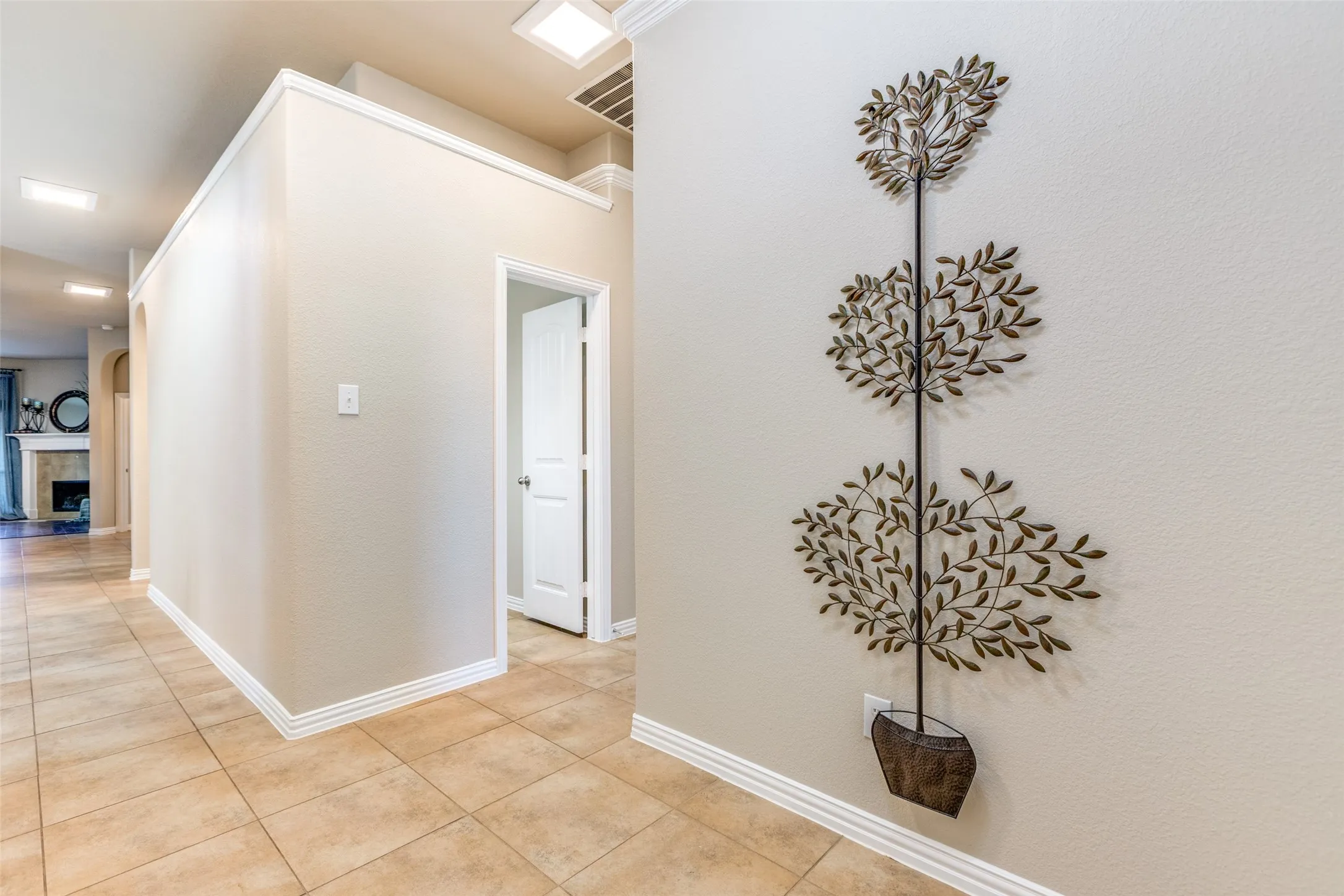 Hall featuring light tile patterned  tile floors and baseboards
