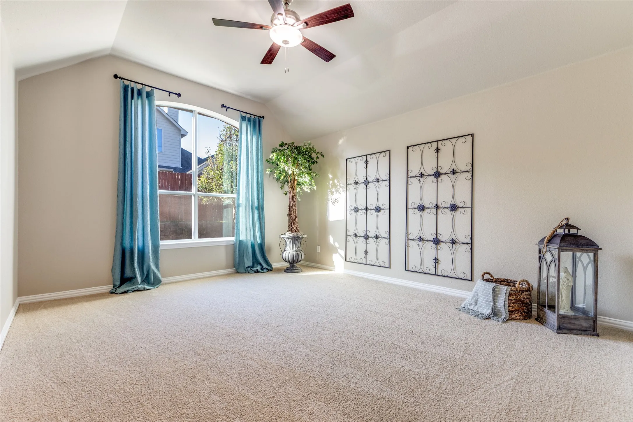 Master Suite featuring vaulted ceiling, carpet floors, and a ceiling fan