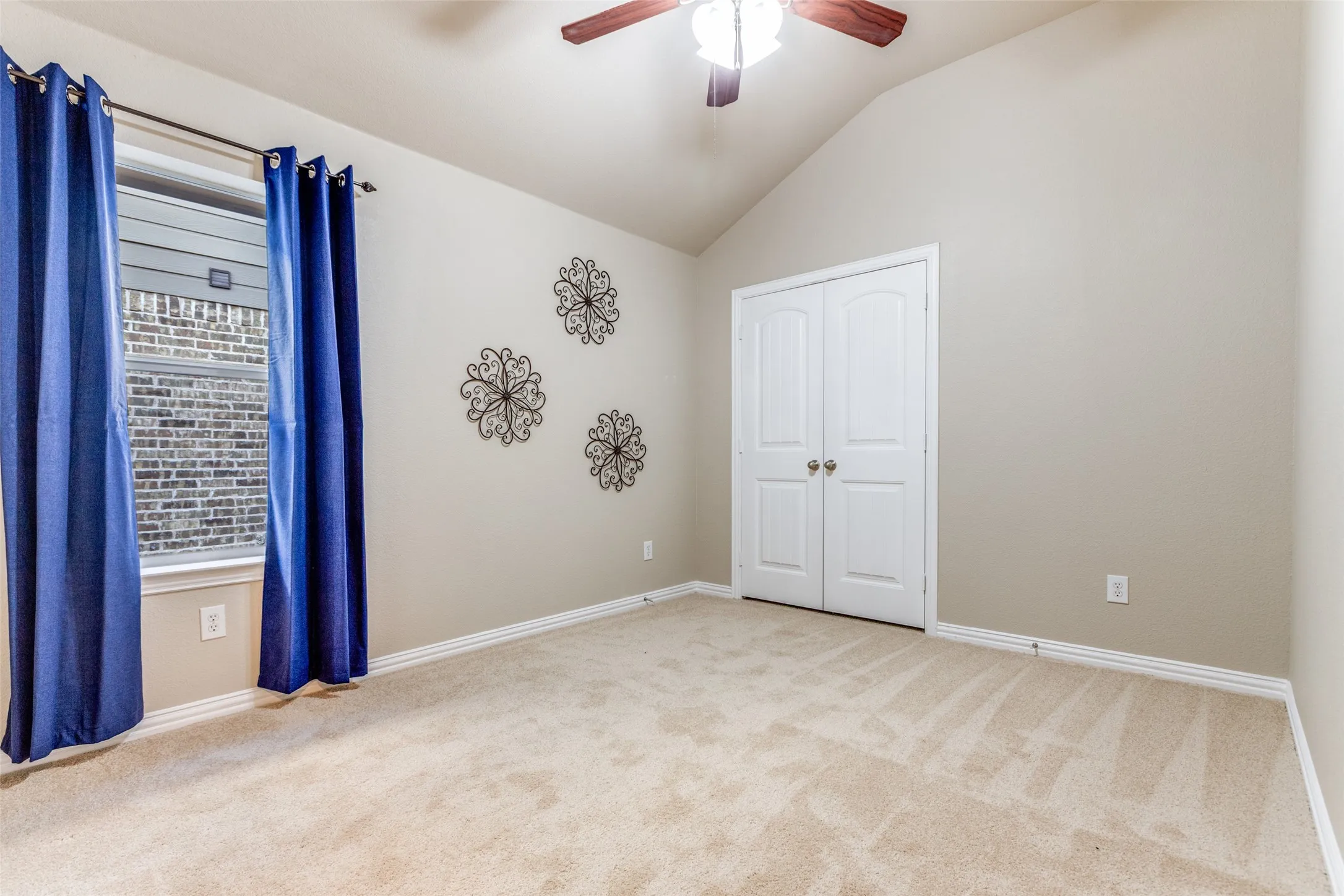 Bedroom featuring lofted ceiling, carpet, ceiling fan, and a closet