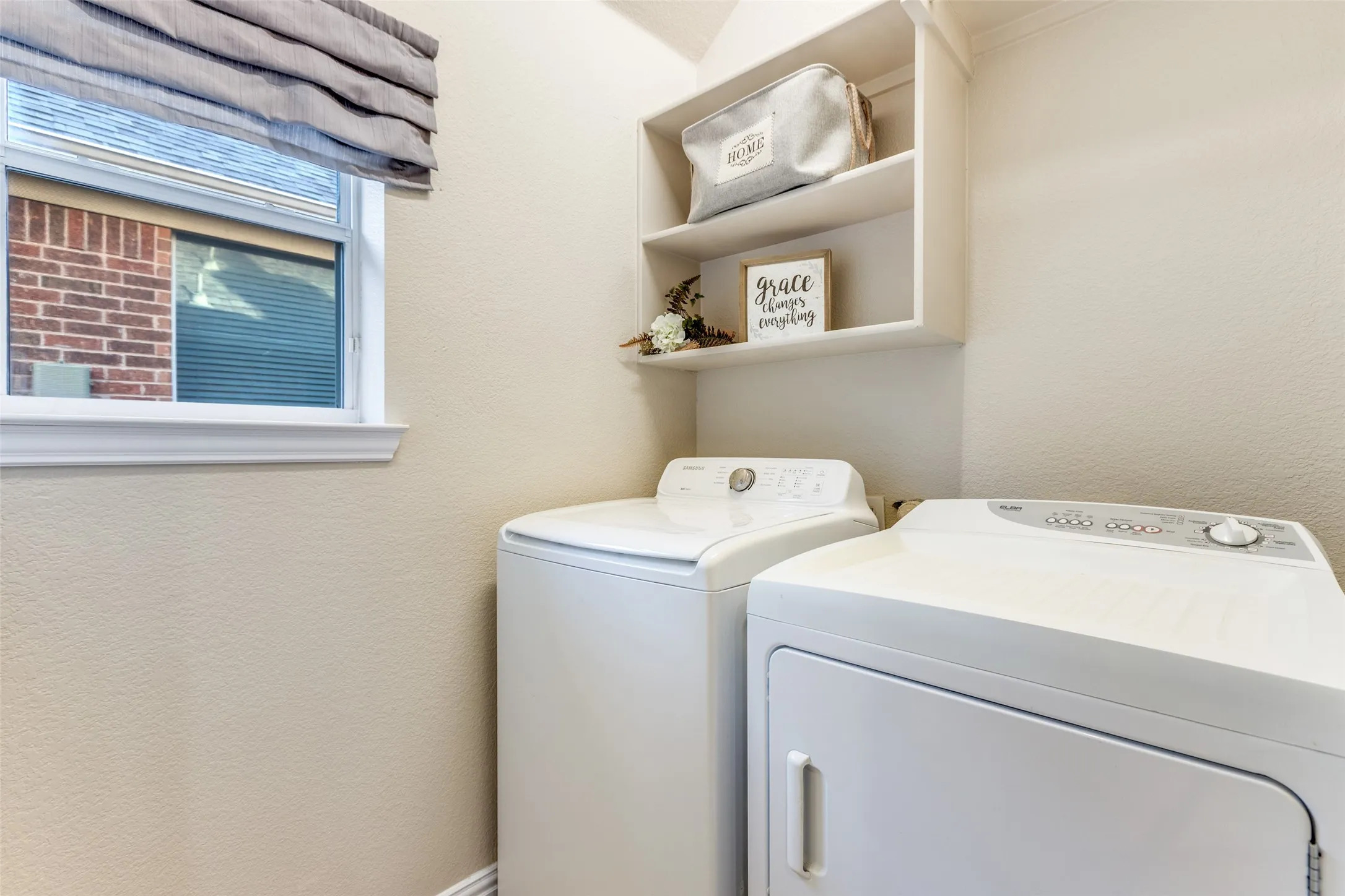 Laundry room with shevles and washing machine and clothes dryer