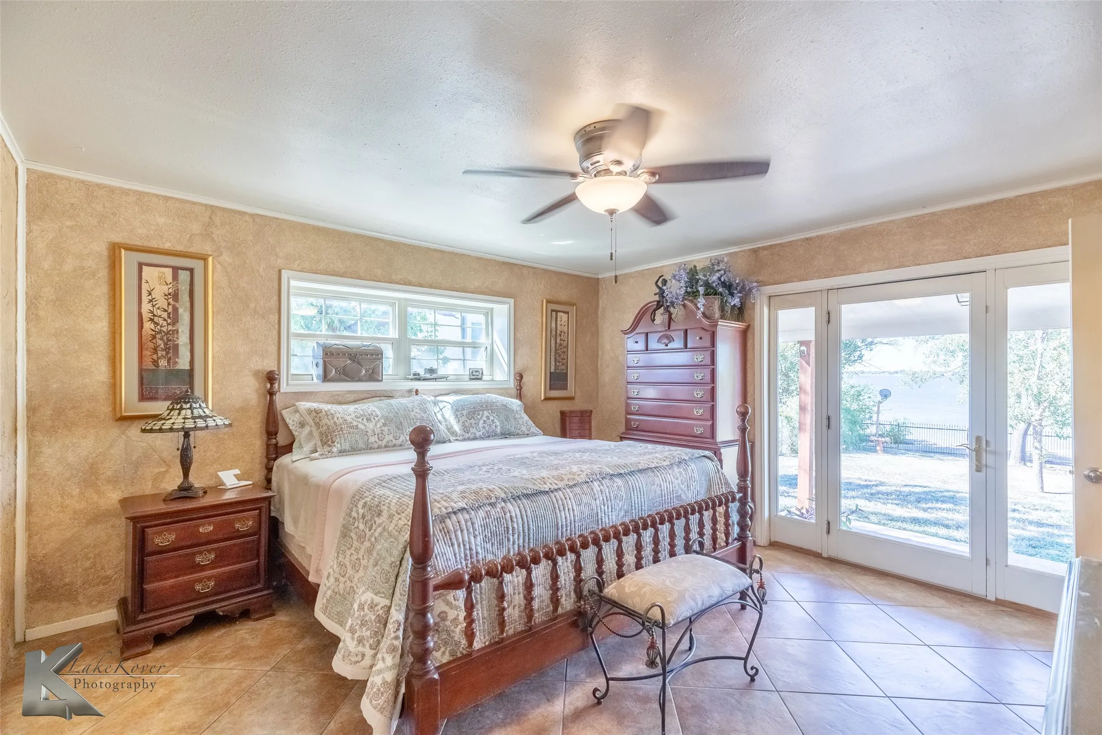 Tiled bedroom featuring access to exterior and ceiling fan