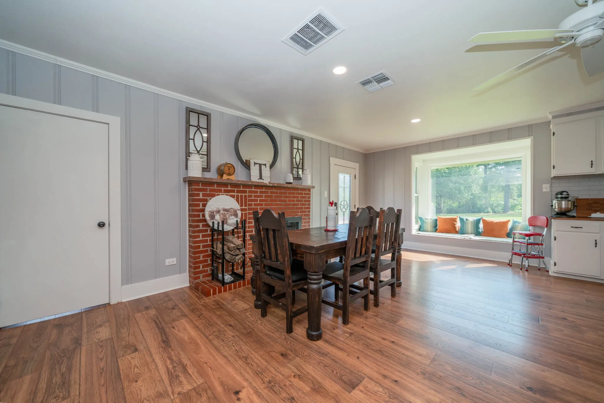 Dining area featuring hardwood / wood-style floors, a brick fireplace, crown molding, recessed lighting, and ceiling fan