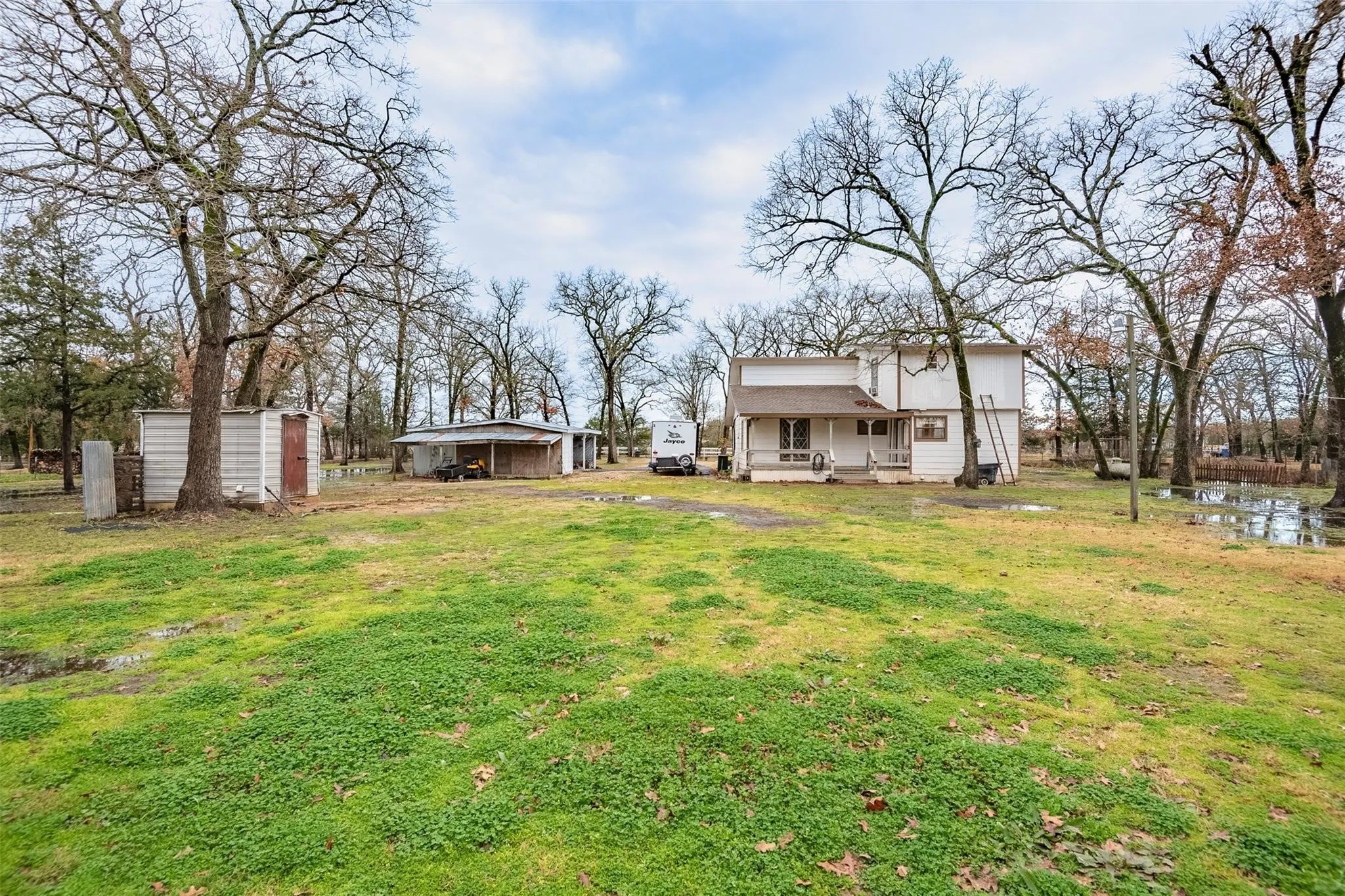 View of grassy yard with an outbuilding