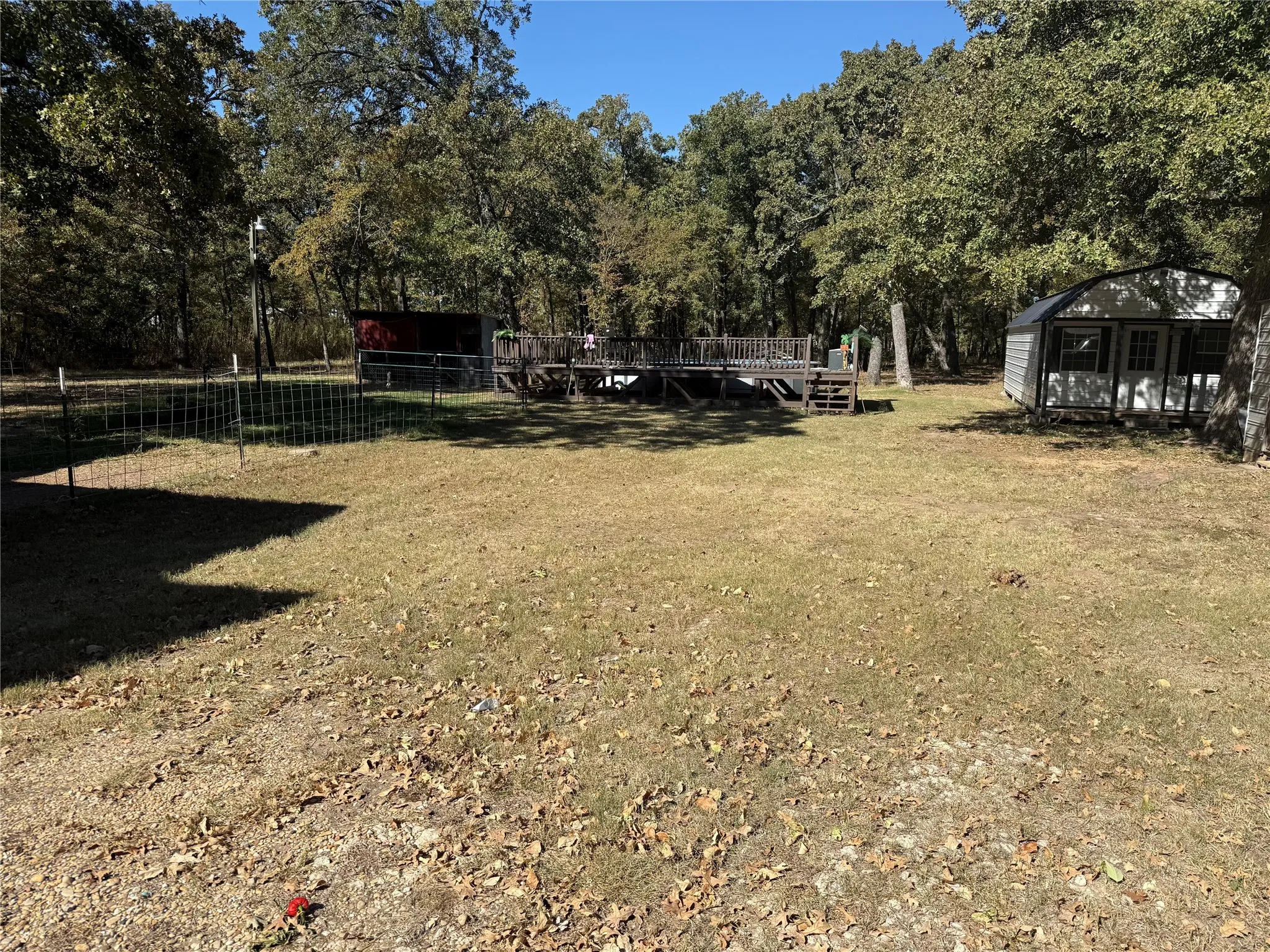 View of yard featuring a shed and a deck