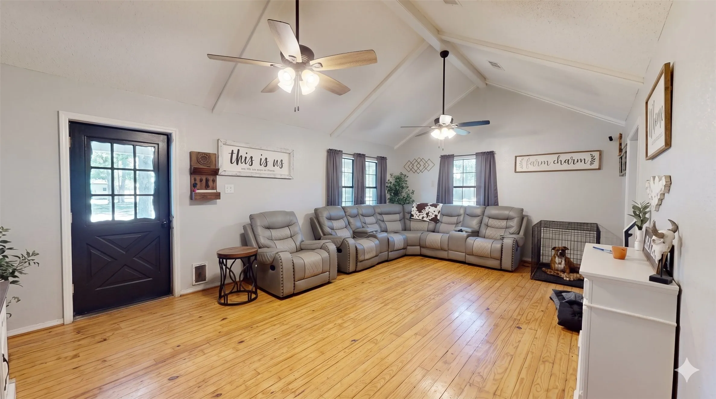 Living area featuring light wood-style flooring, a textured ceiling, and ceiling fan