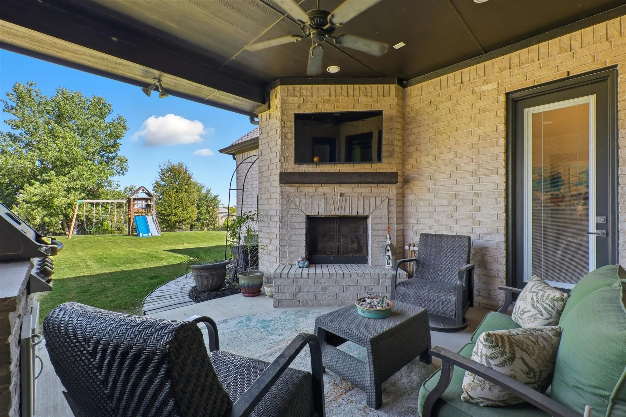 Large, covered patio with fireplace and built-in grill.