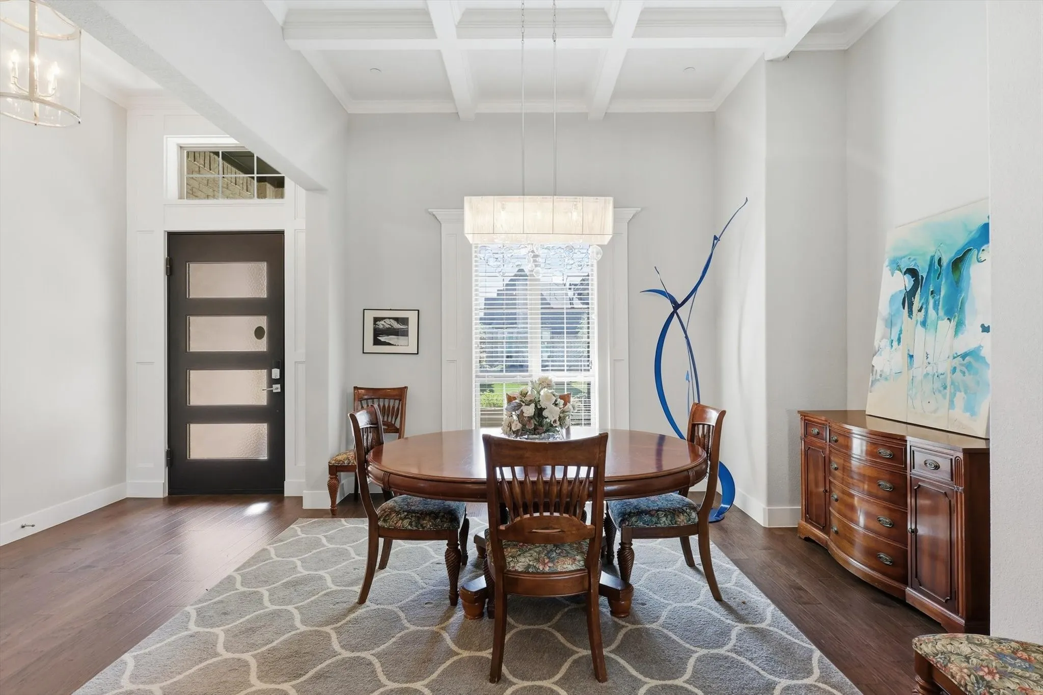 Formal dining area with coffered ceiling could also be enclosed for a study.