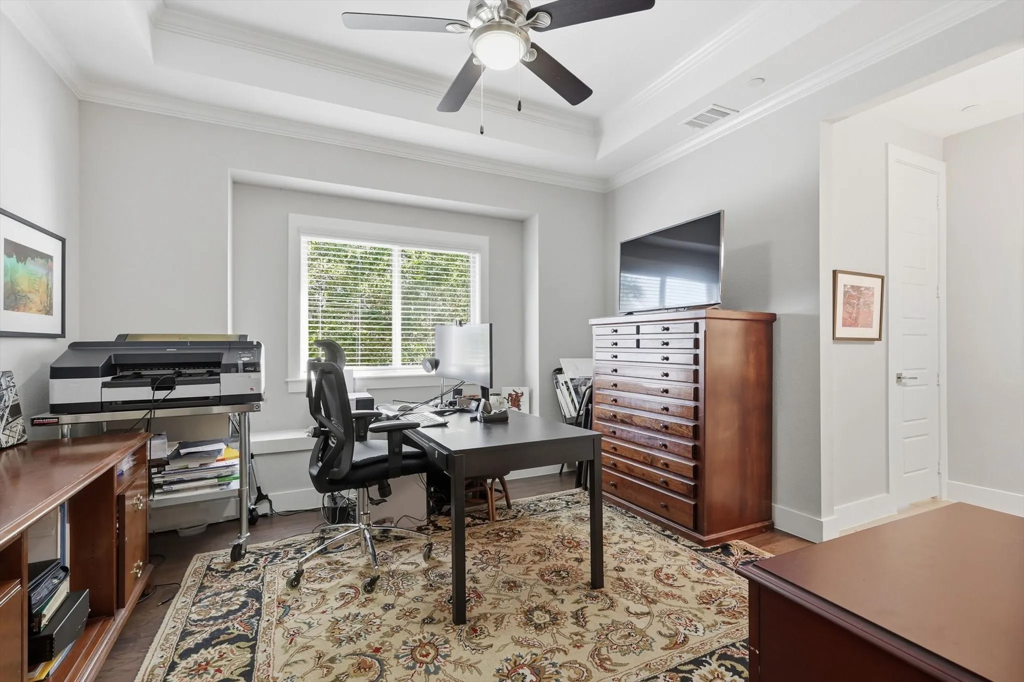 Generously sized with a tray ceiling with ceiling fan, window bench and walk-in closet.
