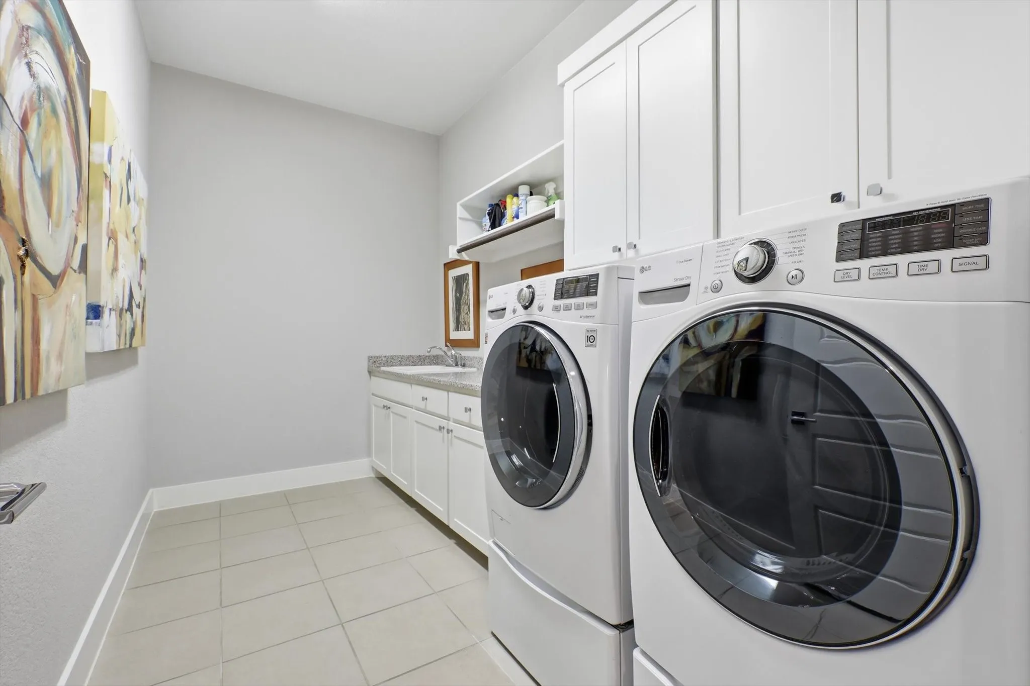 This utility area takes the "chore" out of laundry!  Great storage, sink, drip-dry area, granite counter for folding and room to iron.