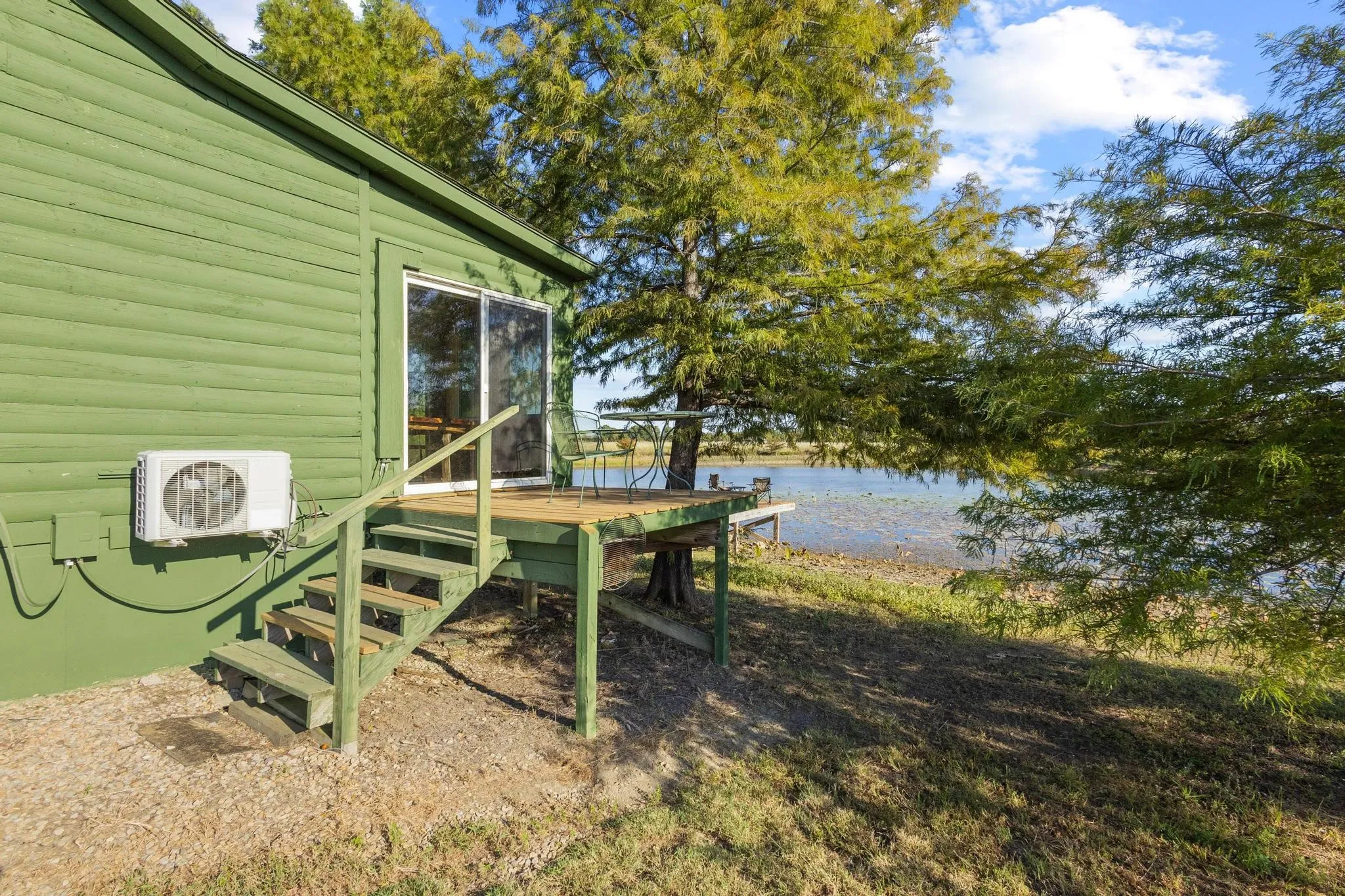 Side deck off of the sunroom is a cute spot for outdoor dining