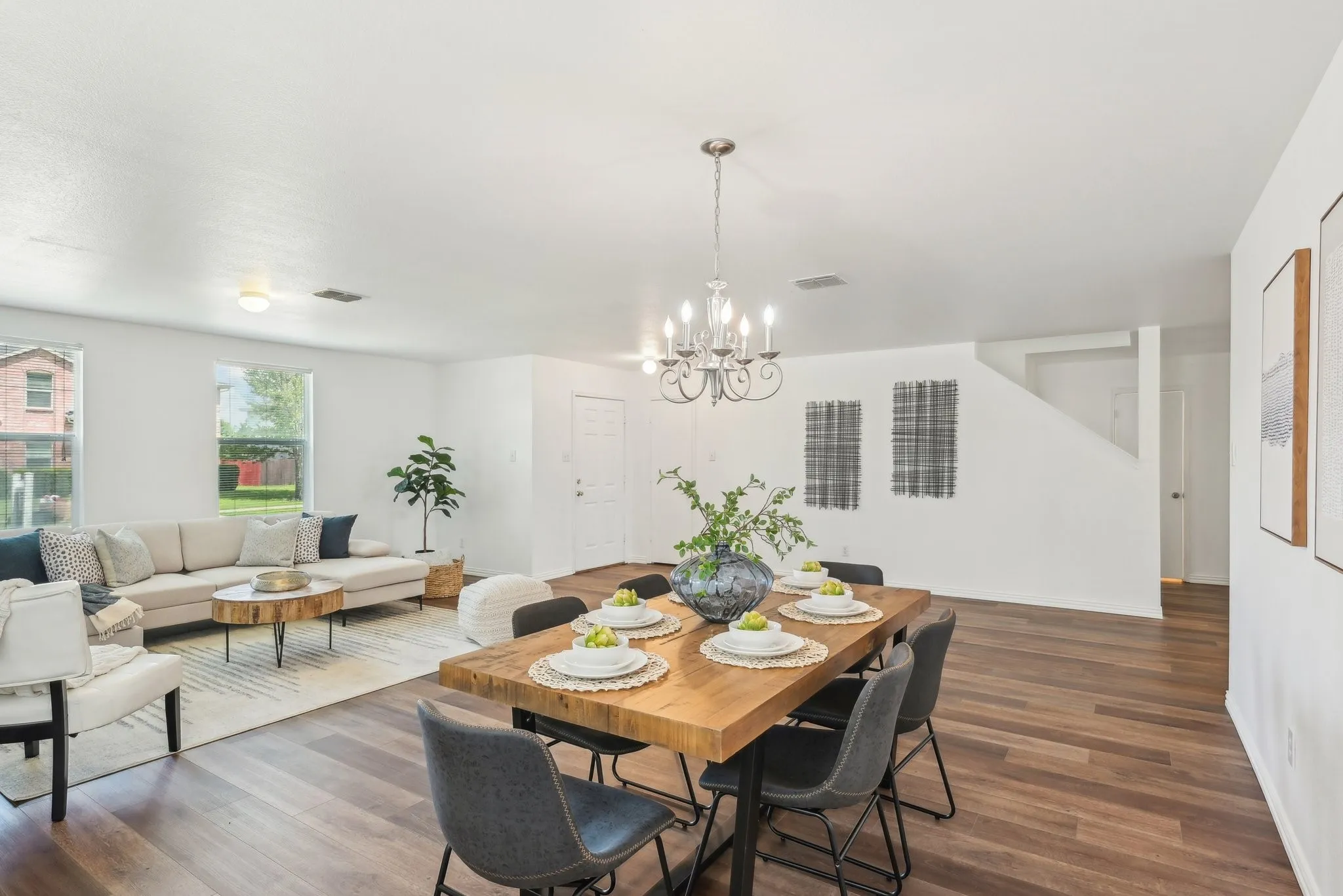 Dining area featuring dark wood-style flooring and a chandelier