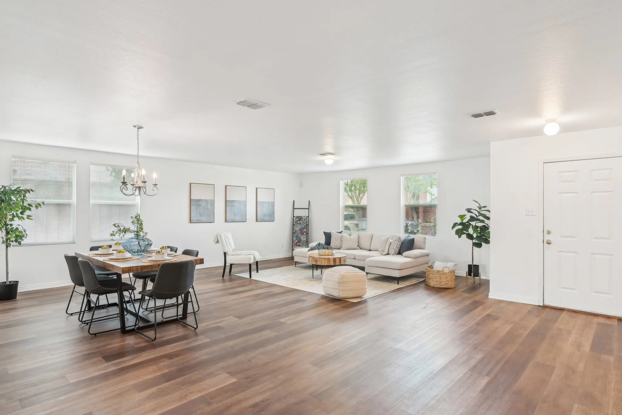 Living area featuring wood finished floors and a chandelier