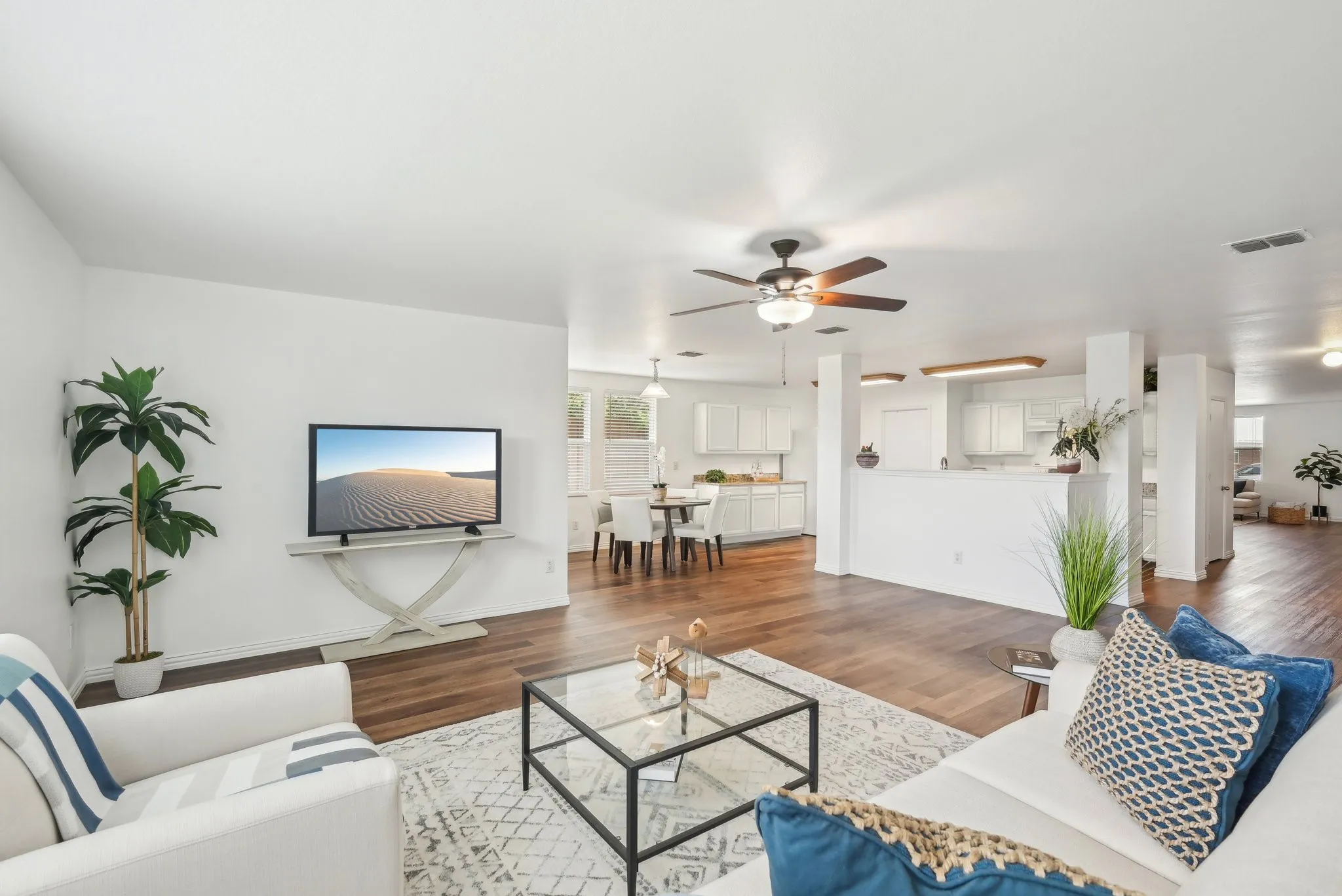 Living room with wood finished floors and a ceiling fan