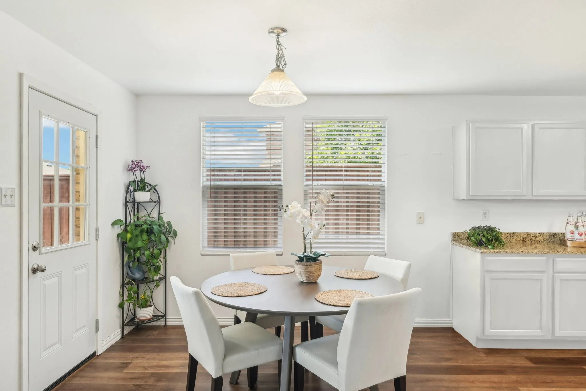 Dining area with dark wood-type flooring and baseboards