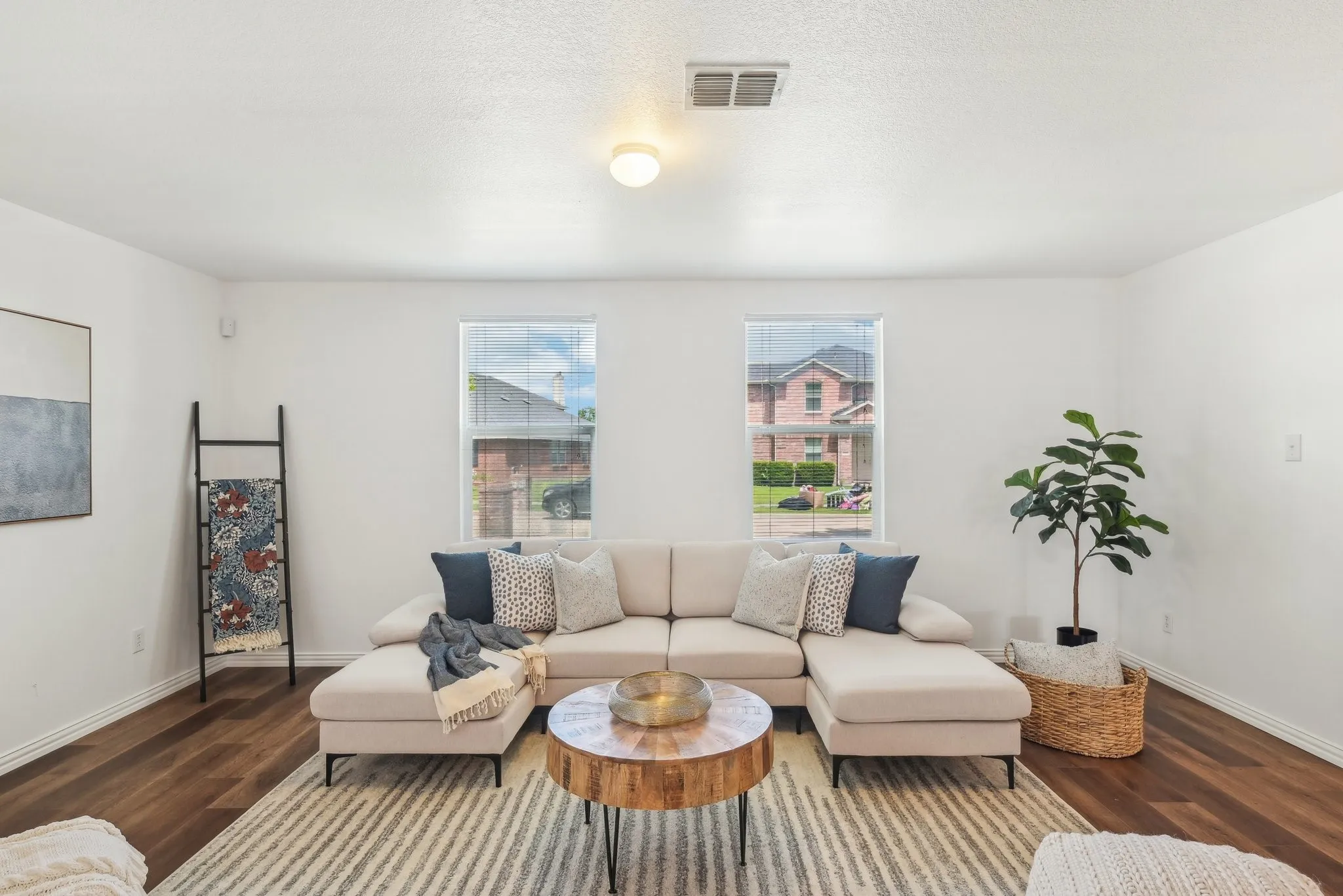 Living area featuring wood finished floors and a textured ceiling