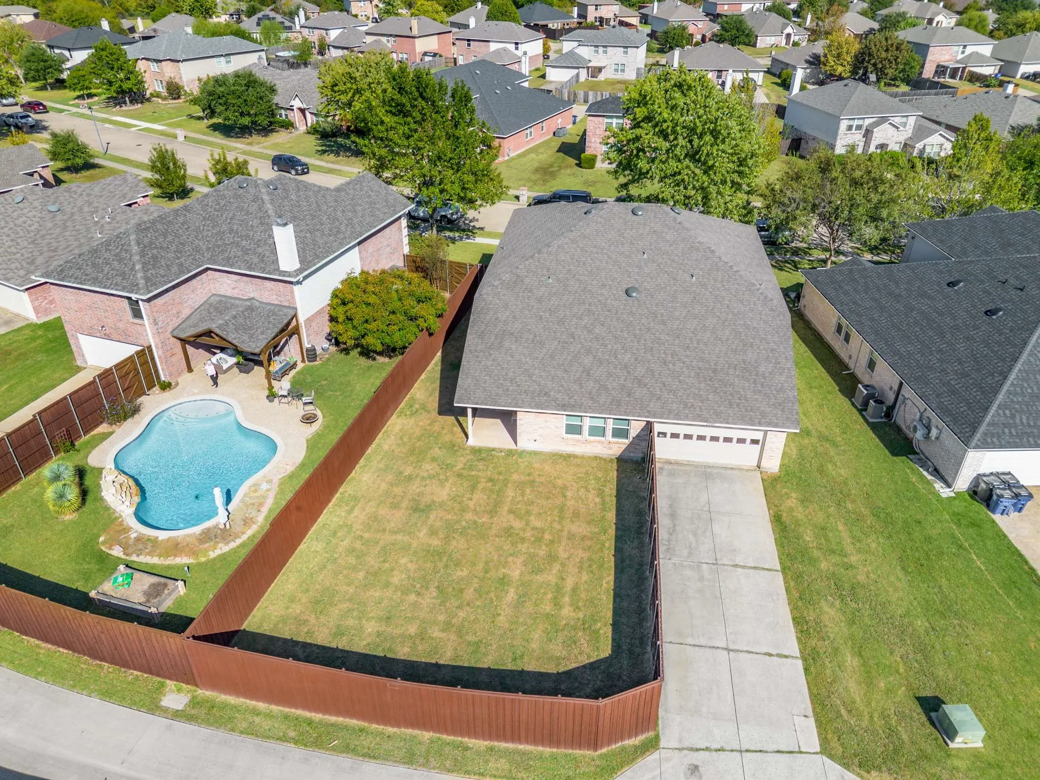 Aerial perspective of suburban area featuring a pool