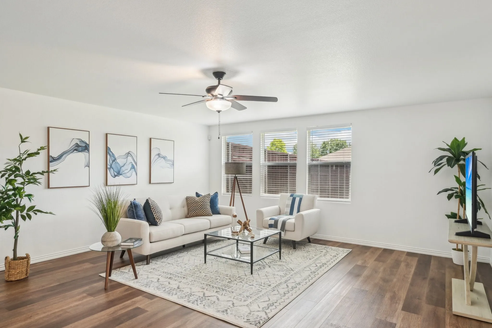 Living area featuring dark wood-type flooring and a ceiling fan