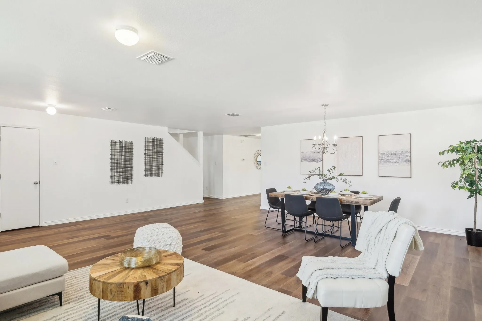 Living room featuring dark wood finished floors and a chandelier