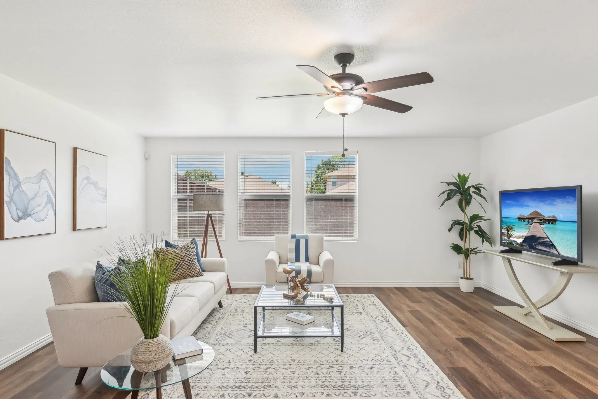 Living area featuring dark wood-type flooring and ceiling fan