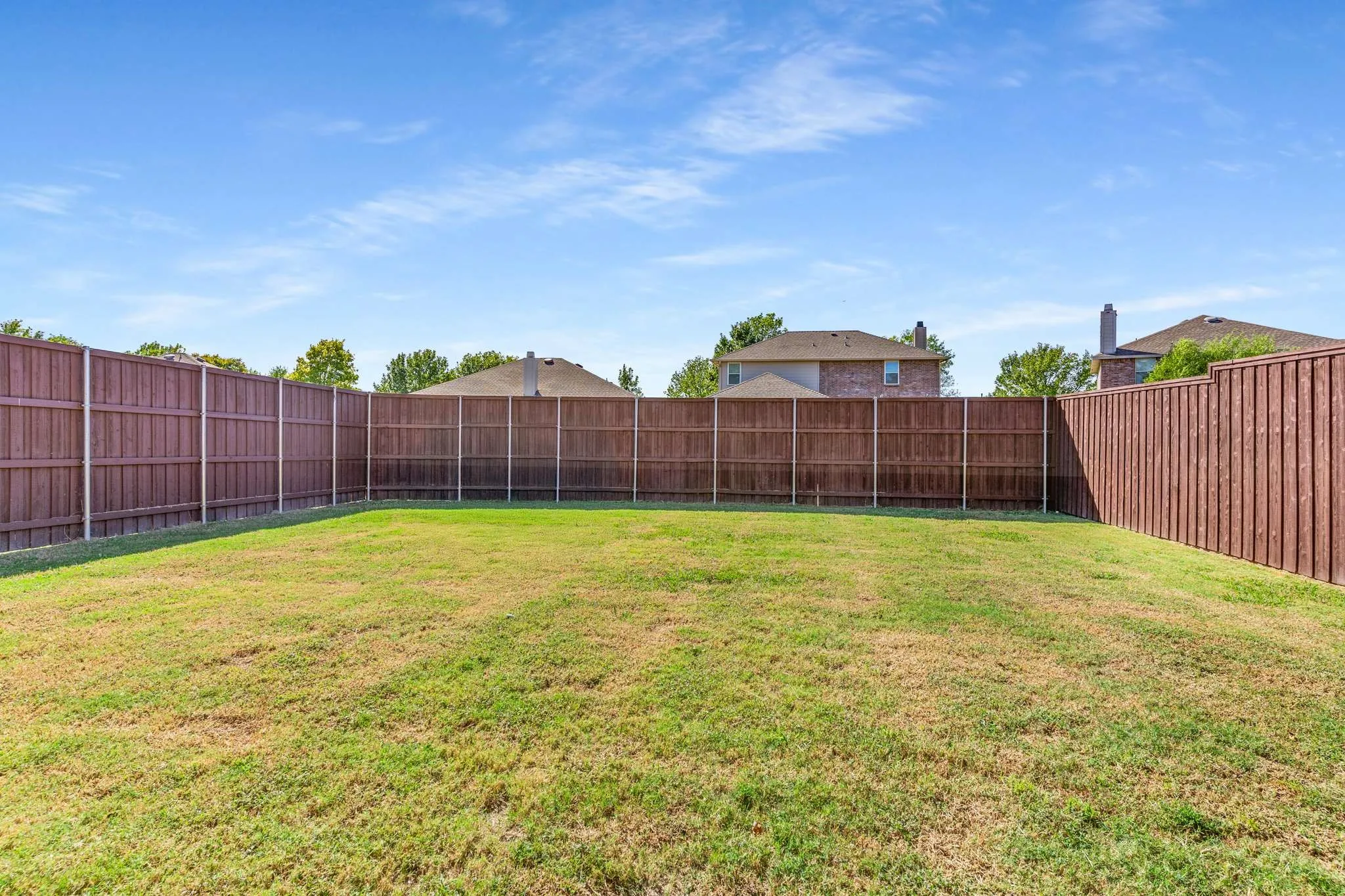 View of fenced backyard