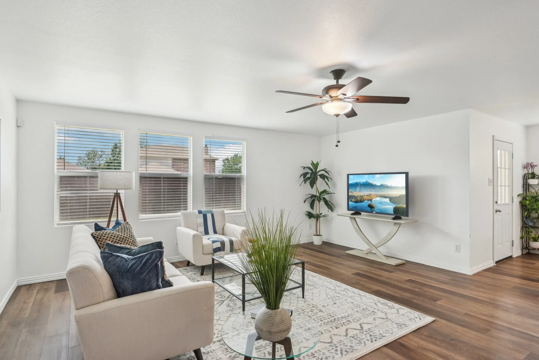 Living area featuring dark wood finished floors and a ceiling fan