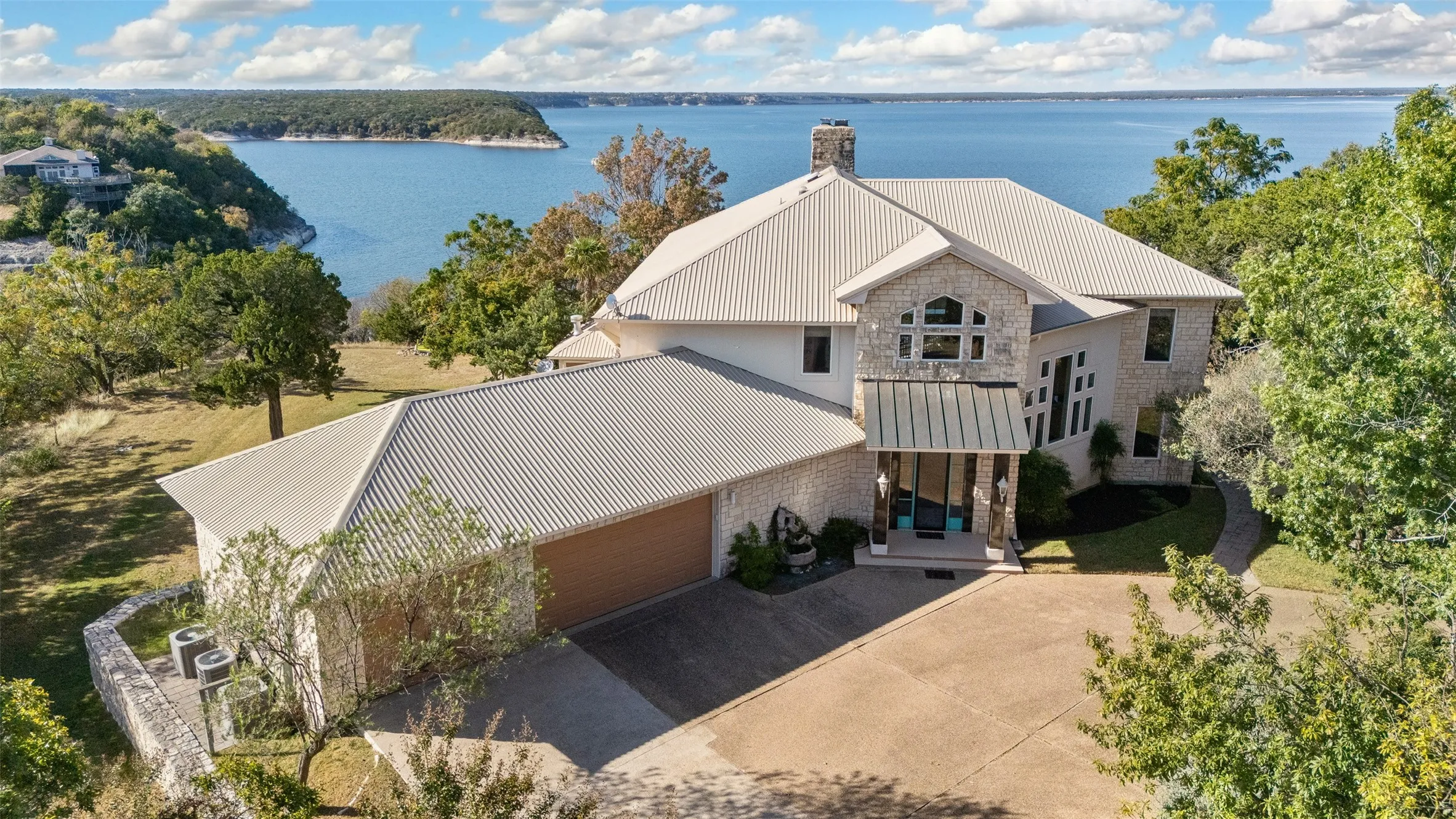 Aerial view of property and surrounding area featuring a nearby body of water