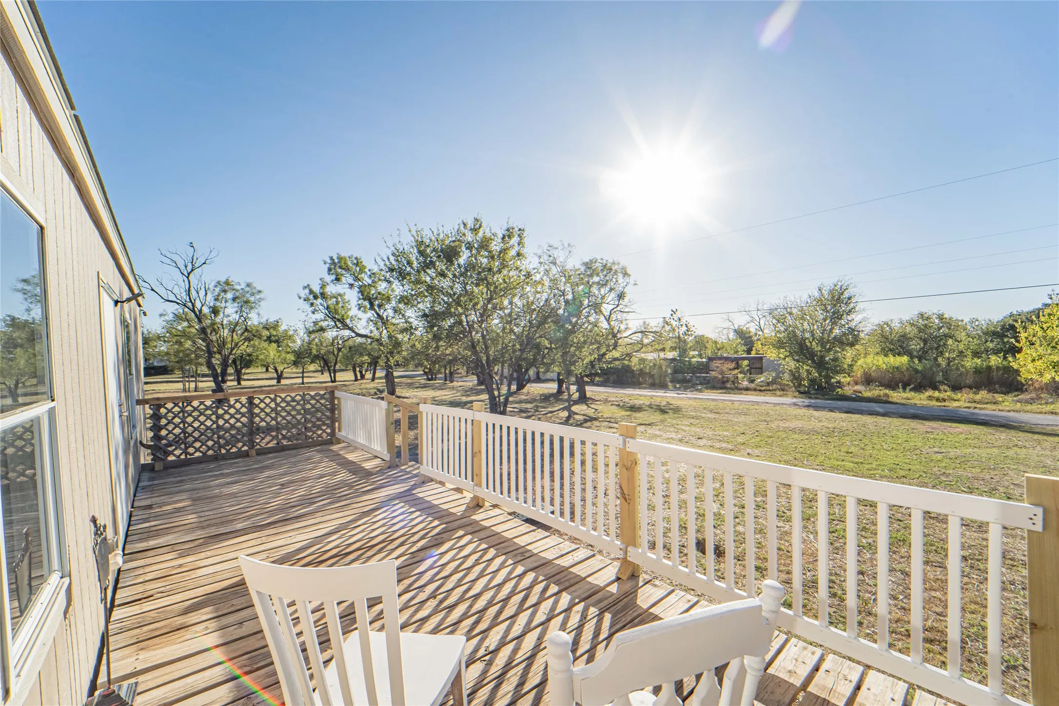 Wooden deck featuring a lawn