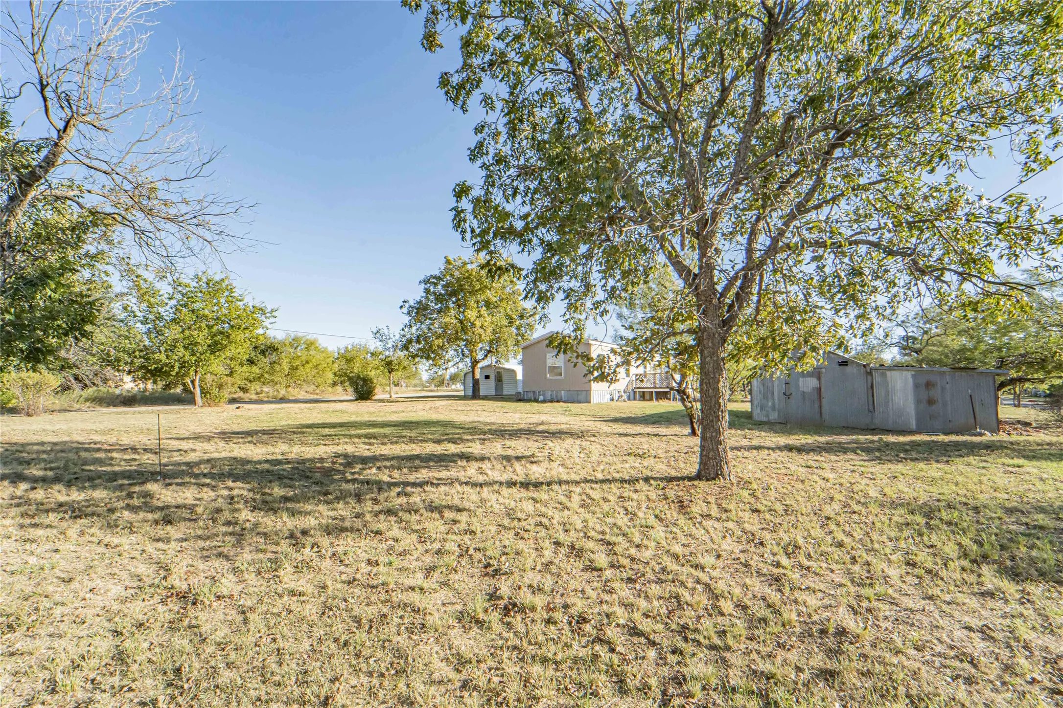 View of green lawn with an outbuilding