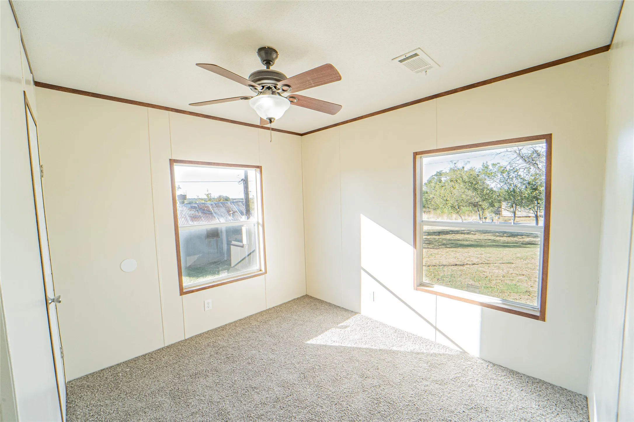 Unfurnished room with crown molding, carpet flooring, and ceiling fan