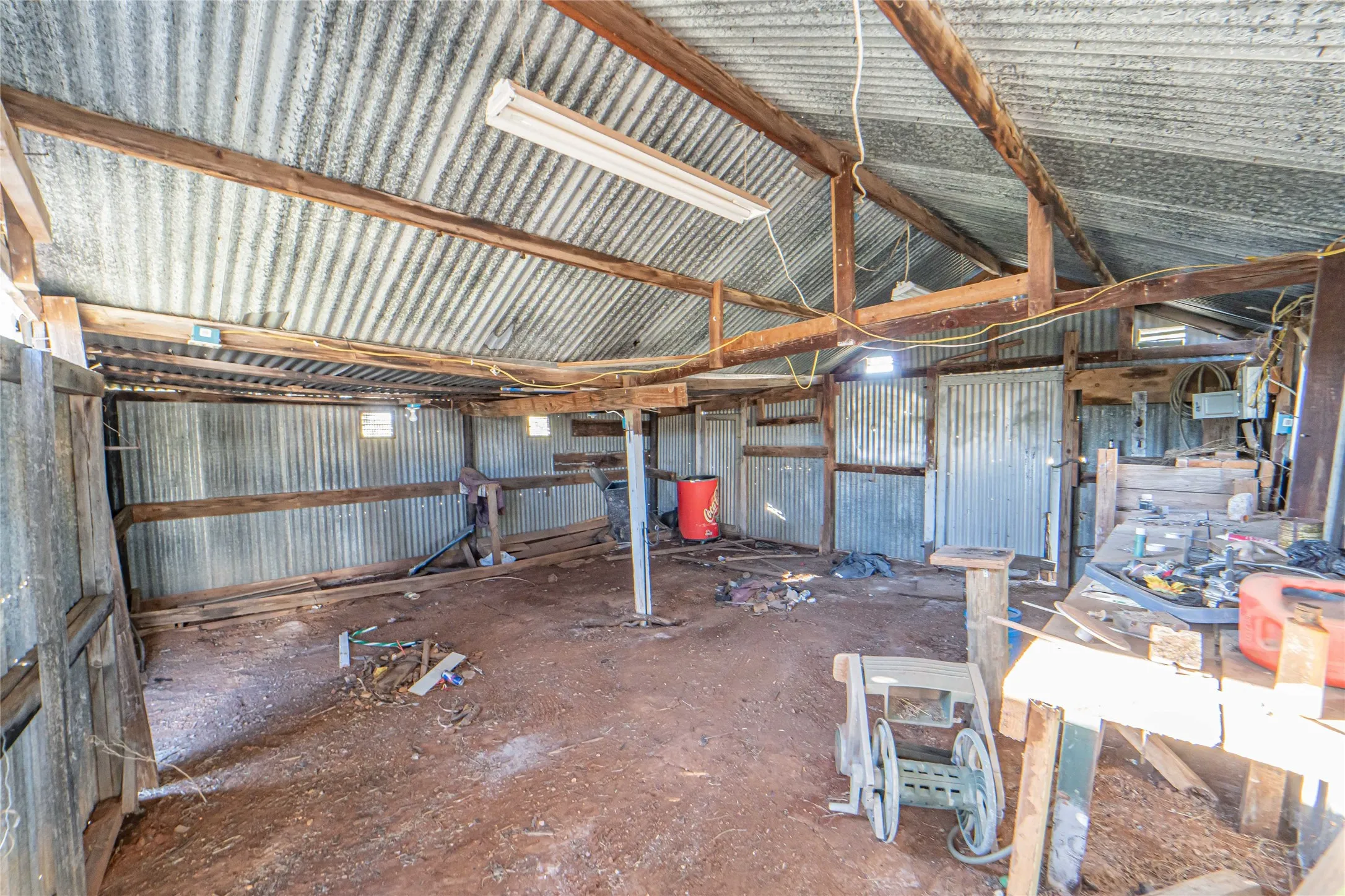 Miscellaneous room with metal wall and vaulted ceiling