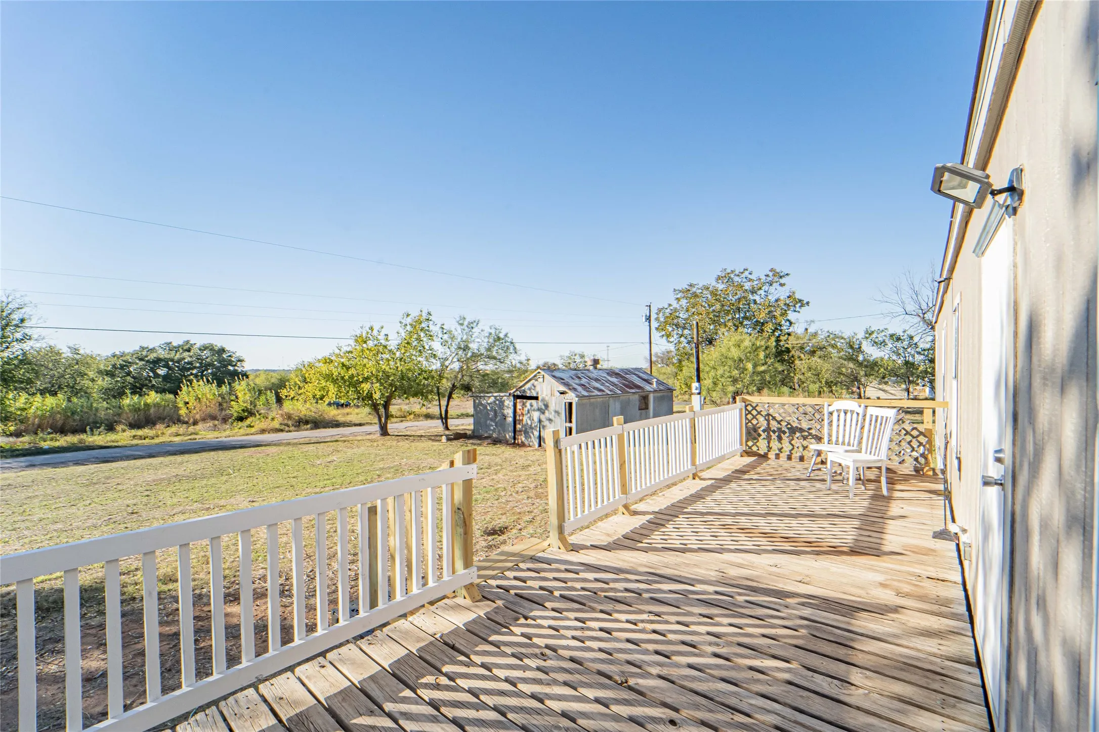 Deck with a lawn and a shed