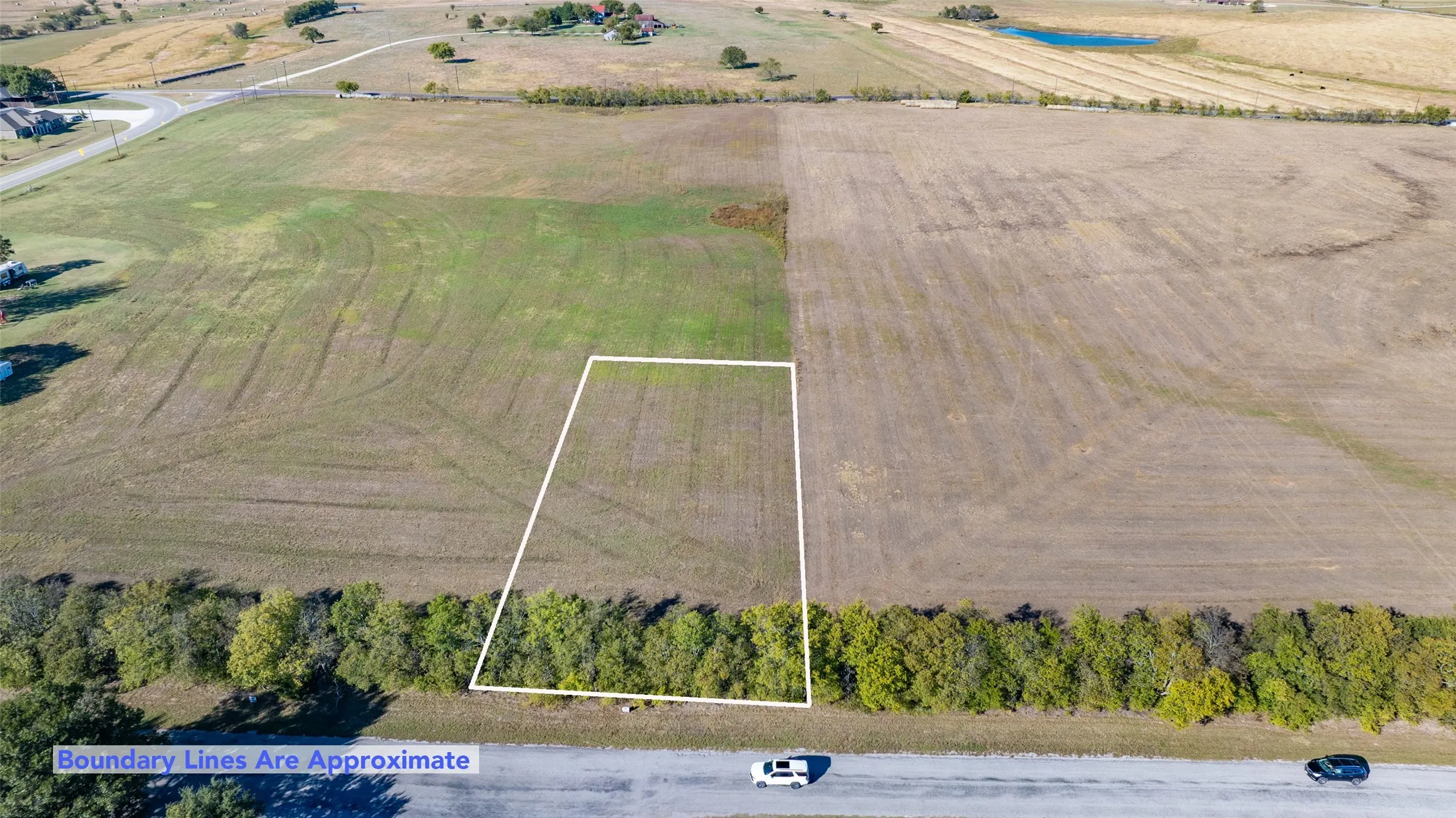 Aerial view of sparsely populated area featuring property parcel outlined