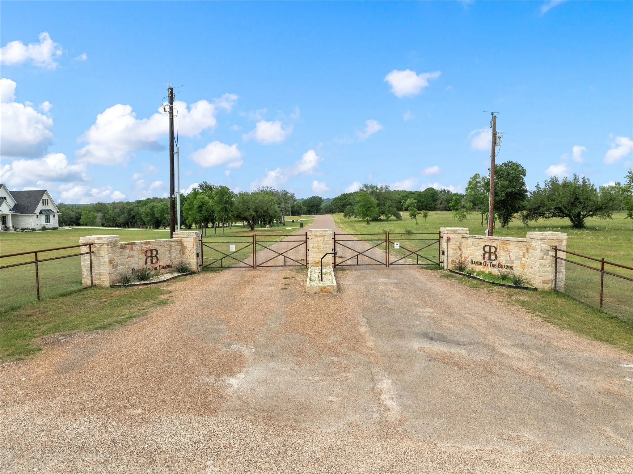 View of road featuring a gate and a view of rural / pastoral area