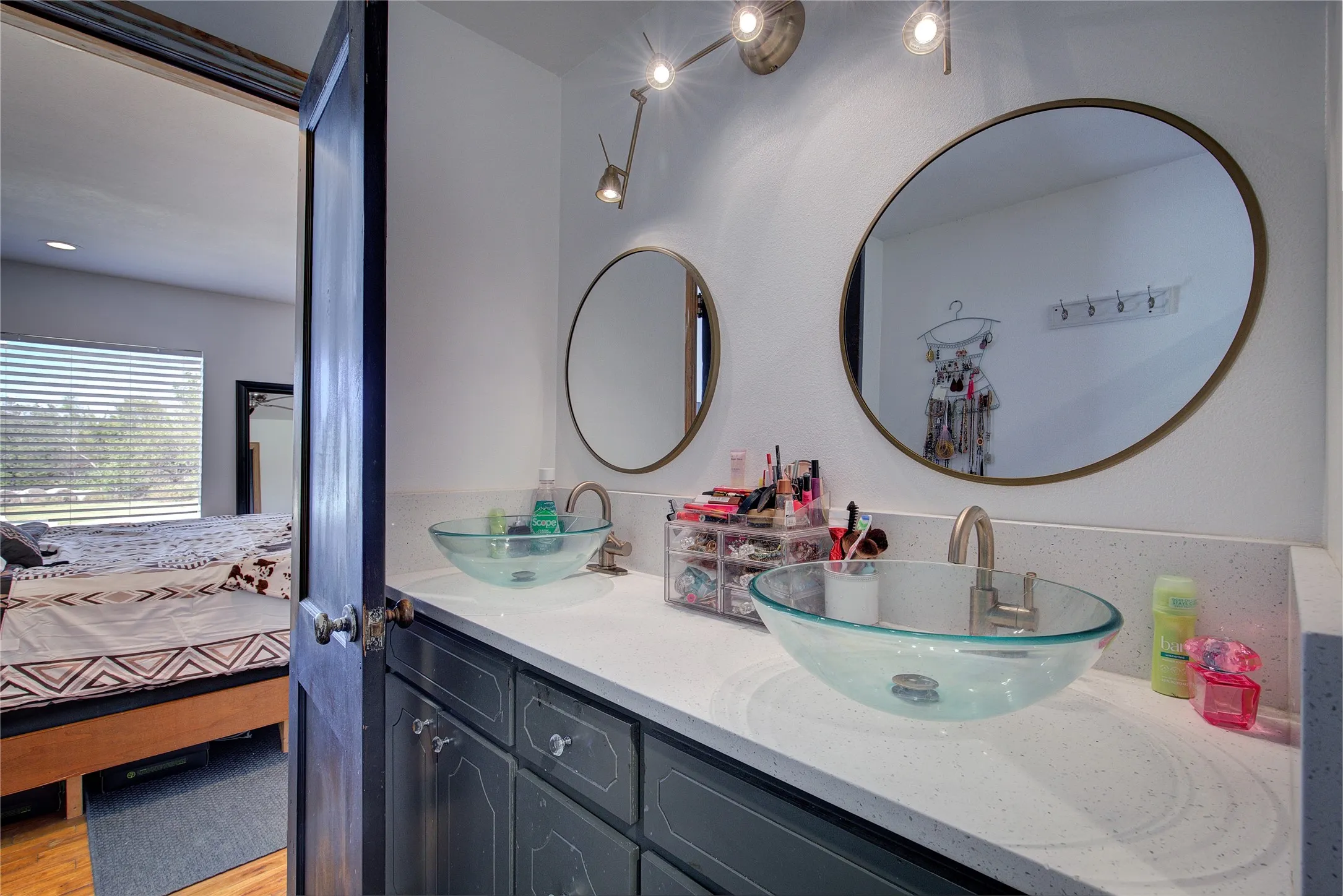 Primary bath has double-sink vanity with granite counters, custom lighting.