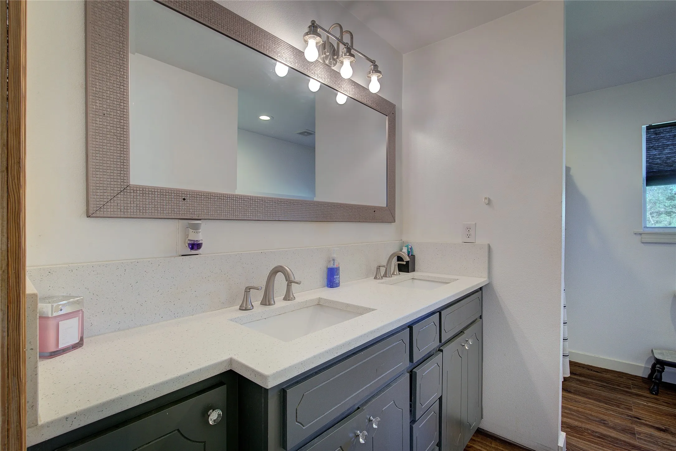 Hall bath has custom vanity with double sinks and granite counter.