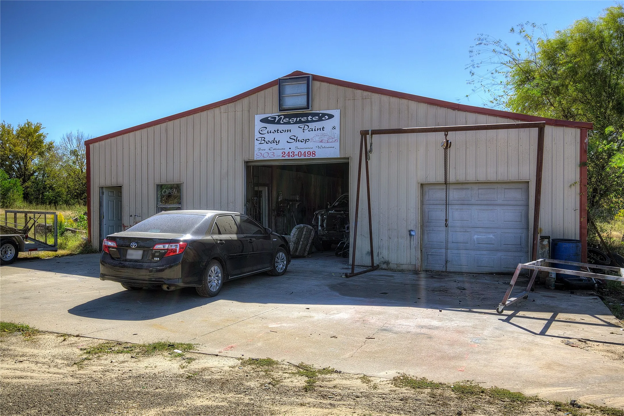 This huge metal workshop is currently in use as a body shop, but has endless options.  Two roll-up doors in front, one in back.