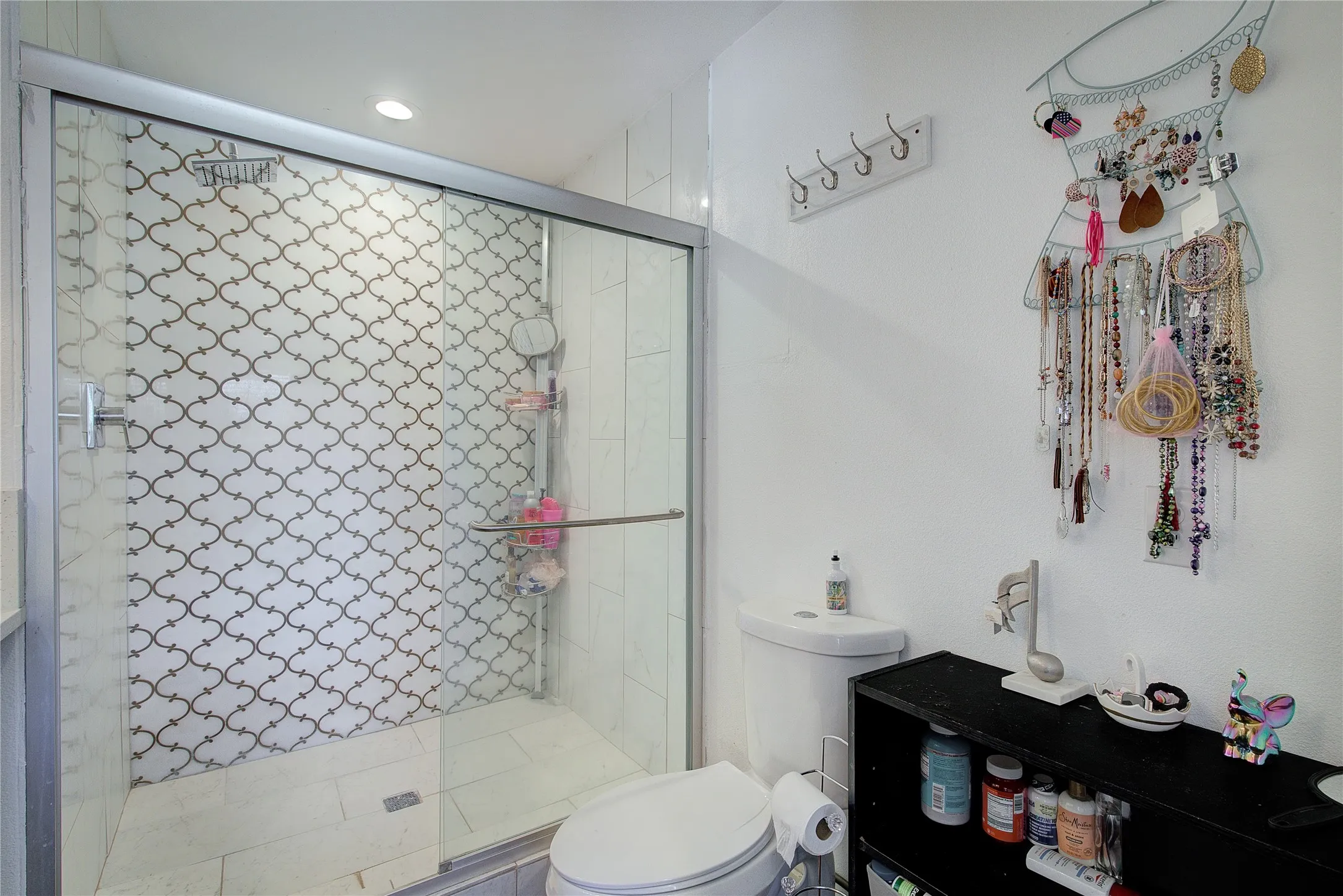 Primary bath has large walk-in shower with custom tiling.